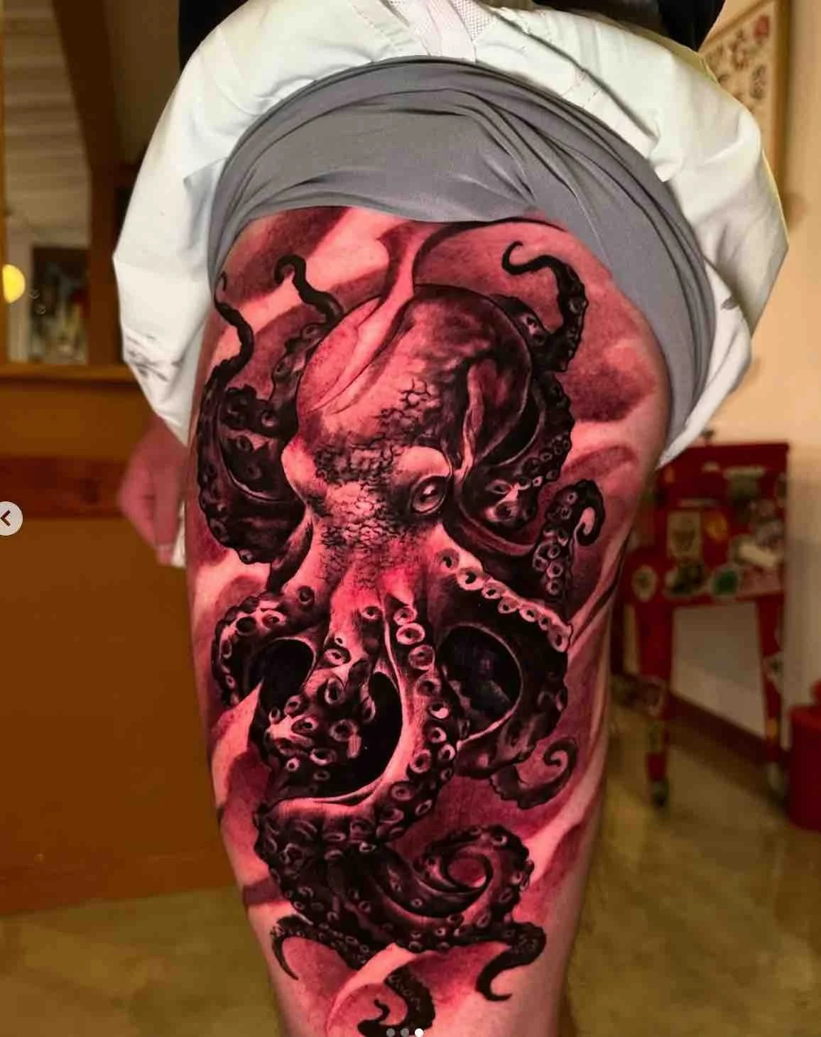 Black-and-red-octopus-thigh-sleeve-tattoo-realism.jpeg