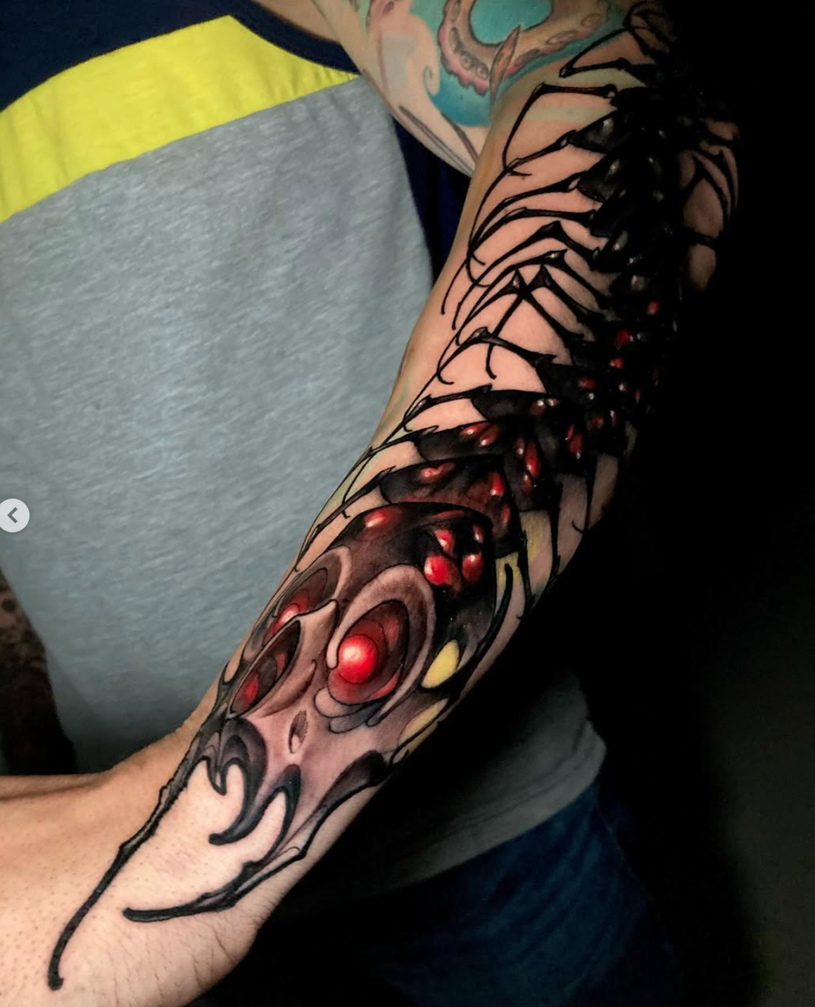 dark-centipede-forearm-sleeve-tattoo-black-and-red.jpeg