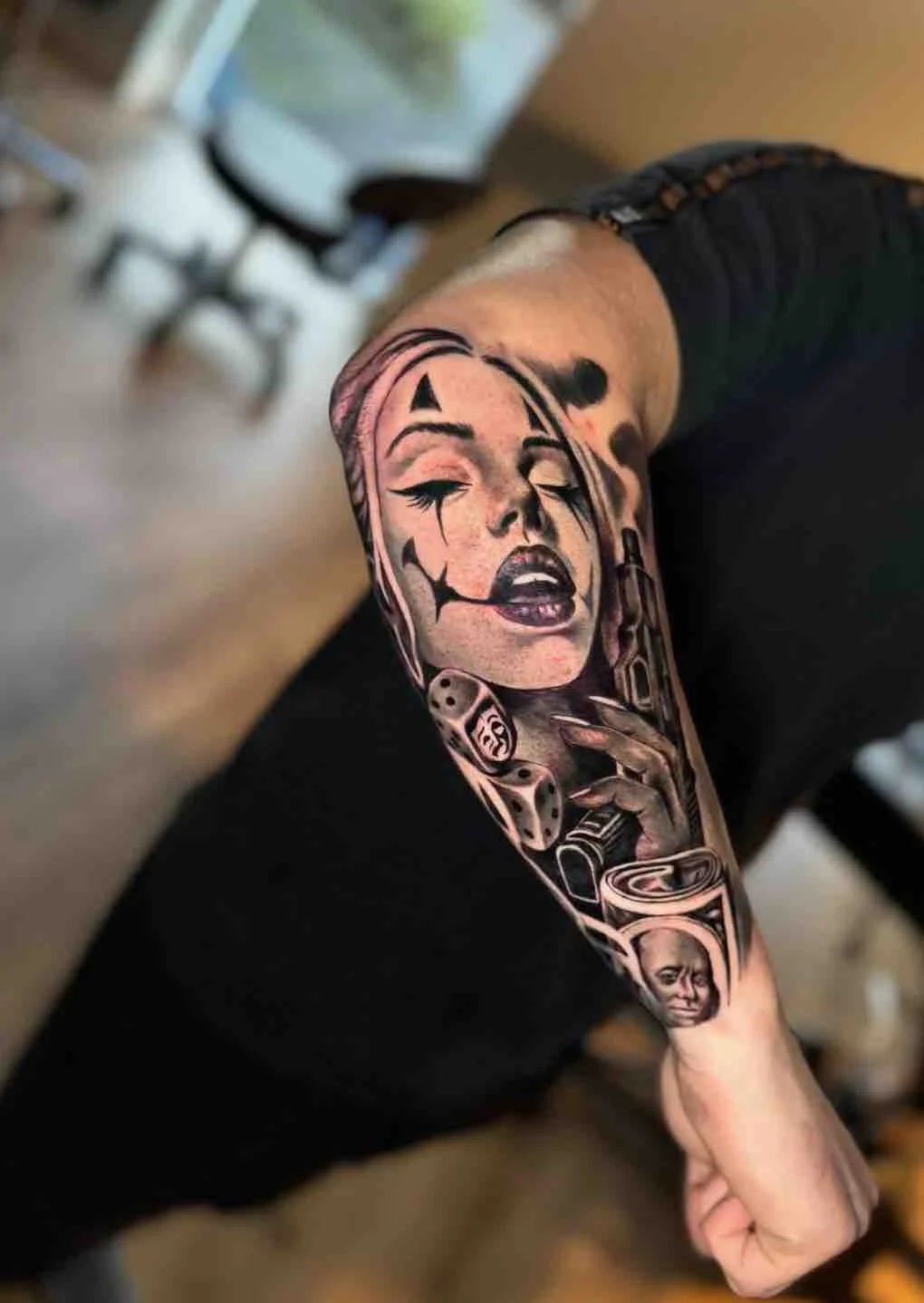 Jester-girl-harley-quinn-forearm-sleeve-black-and-grey-tattoo.jpeg