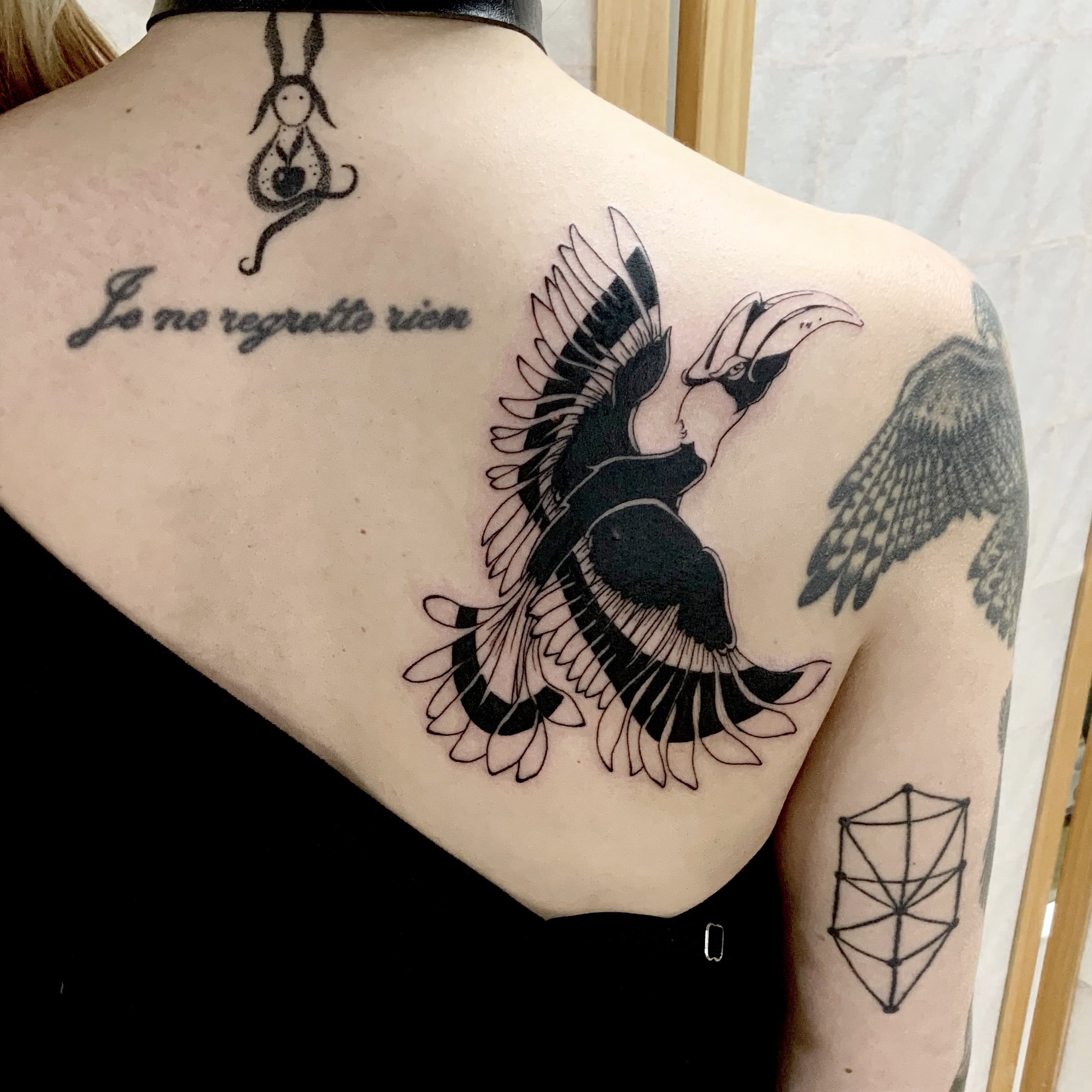 Bird tattoo idea in blackwork tattoo style