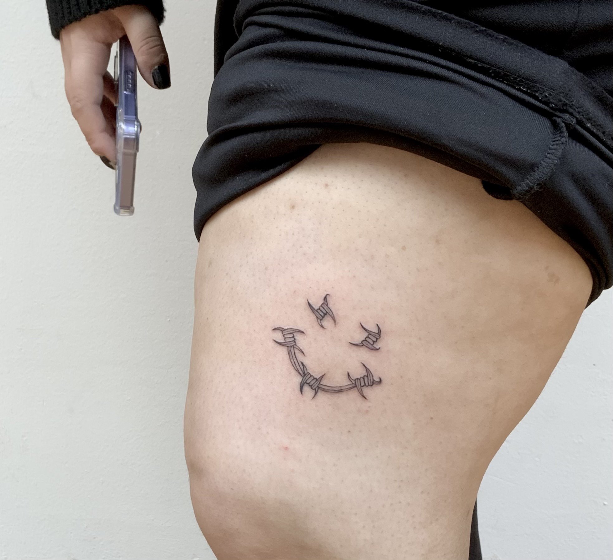 Fine lines tattoo idea of smiley face