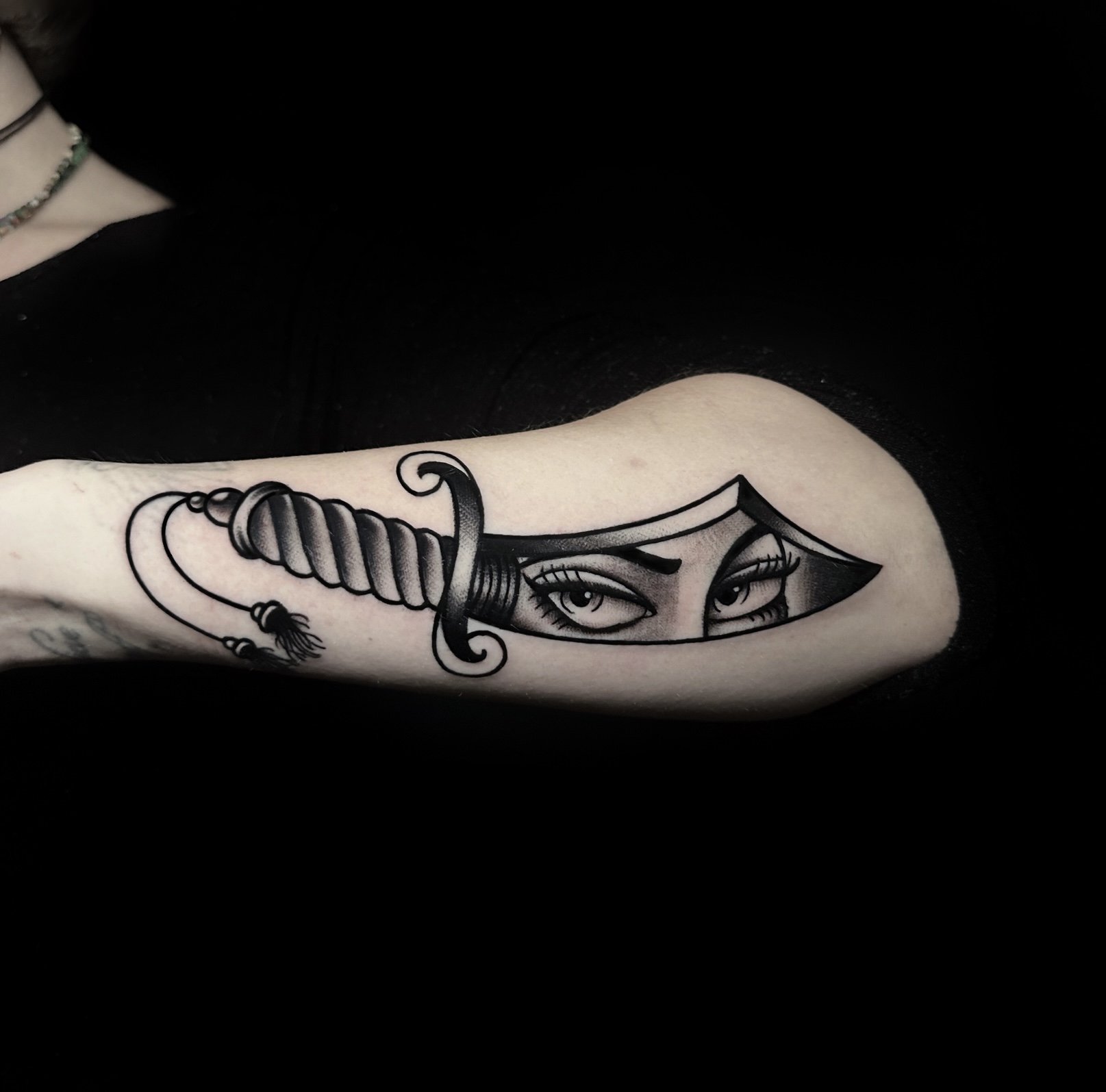Dagger tattoo idea on arm in blackwork tattoo style