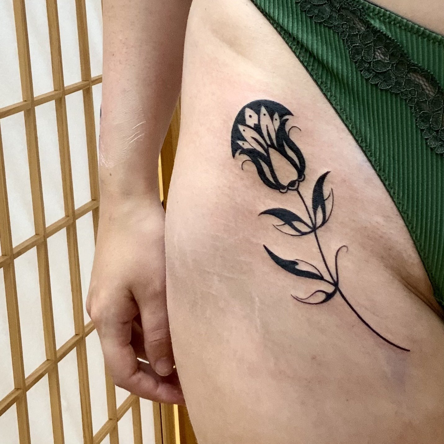 Tulip tattoo idea in blackwork tattoo style
