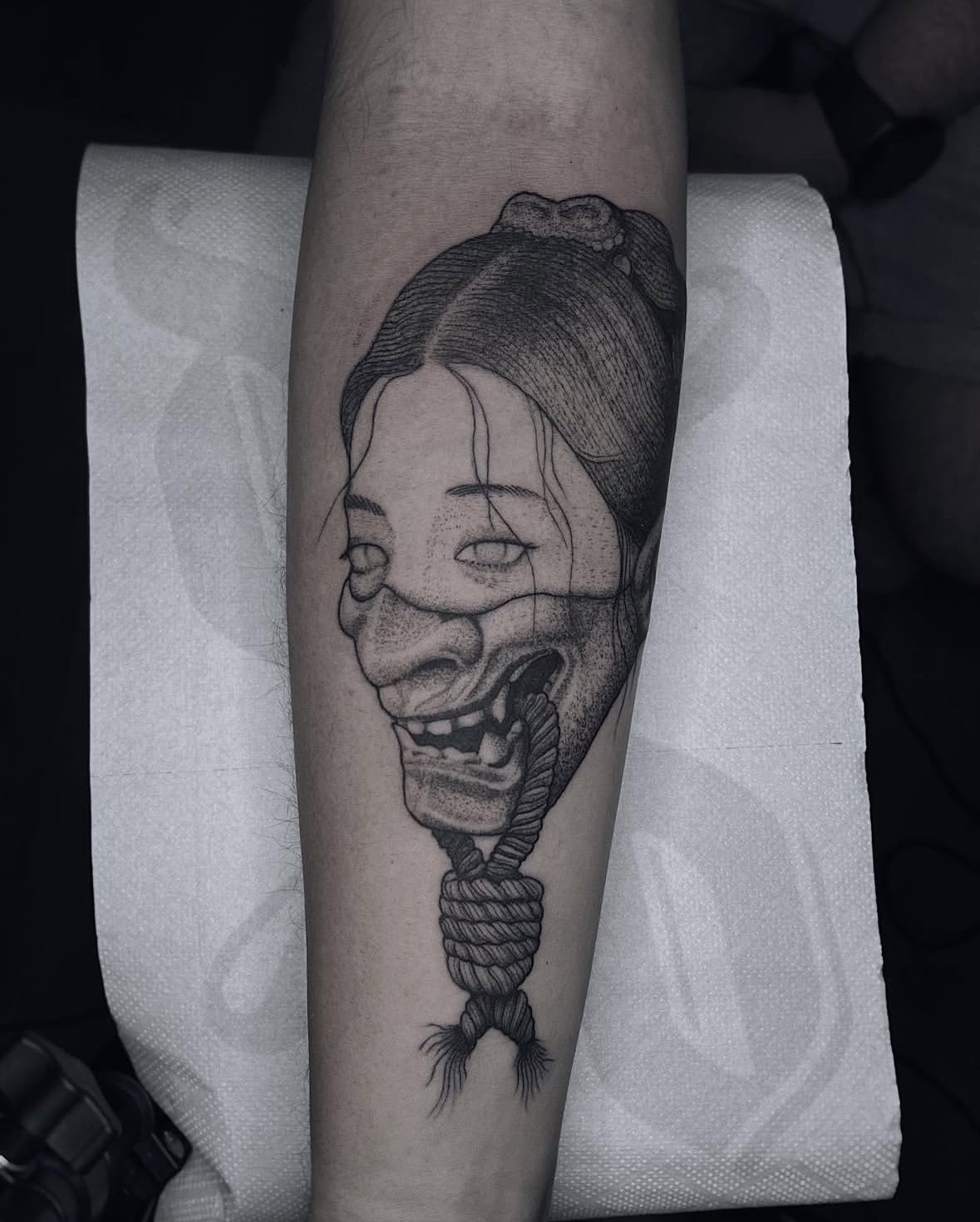 A yokai tattoo placed on the inner forearm, created exclusively using black ink By Davila