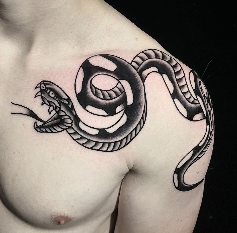 Snake tattoo idea on shoulder in blackwork tattoo style