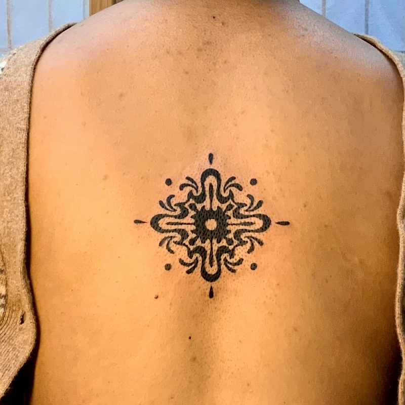 Symetric mandala tattoo idea on back