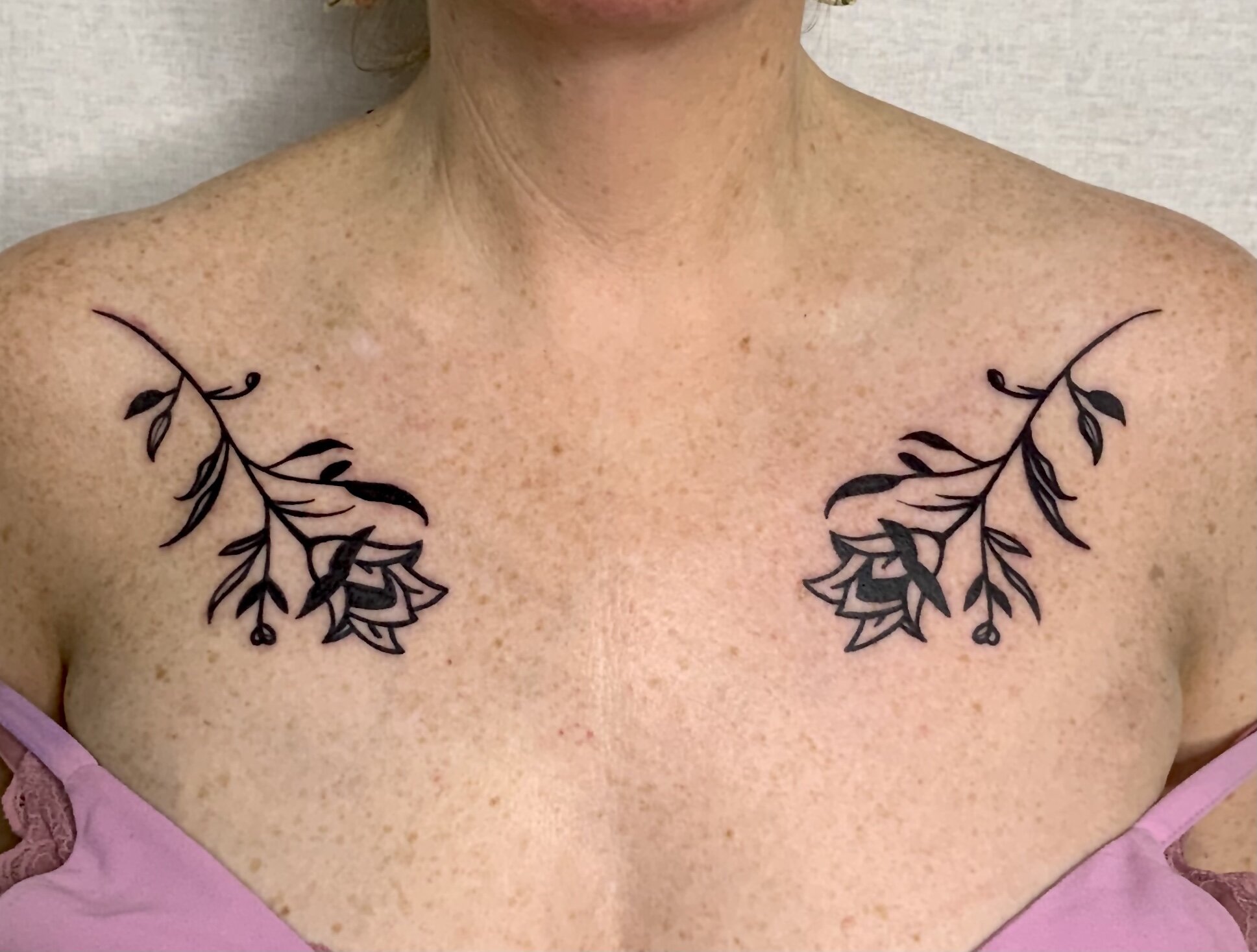 Rose tattoo idea on chest for woman in blackwork tattoo style