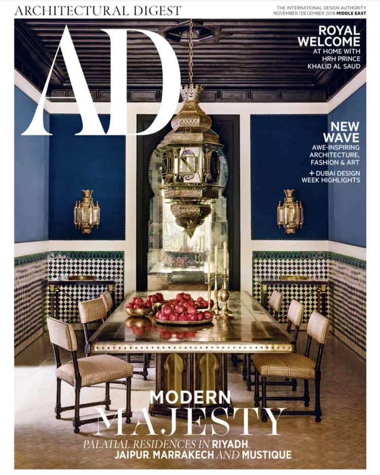 Architectural Digest Middle East magazine cover featuring an elegant Moroccan-inspired dining room interior with brass table and lantern chandelier
