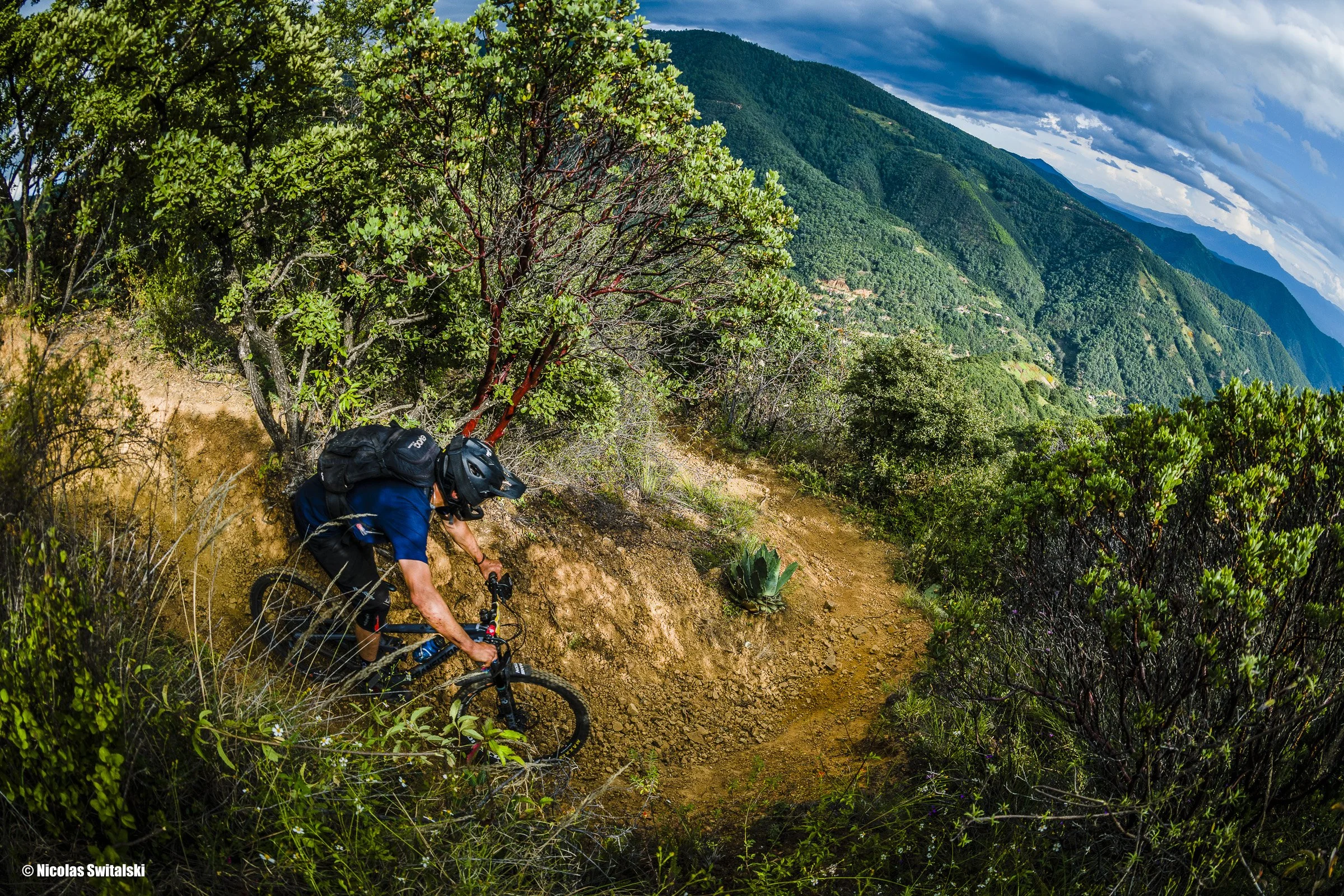 High Take of Enduro mountain bike rider descending a technical trail in Oaxaca Mexico