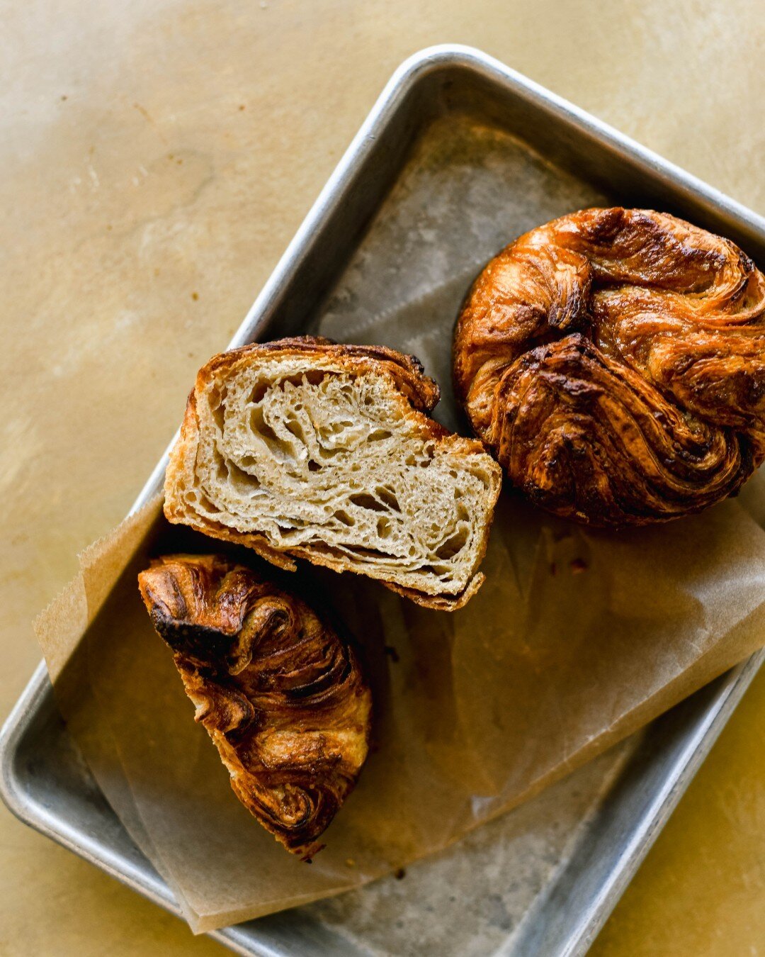 The classic kouign amann is a laminated and leavened pastry akin to croissants and danishes, only with sugar laminated into the layers. The best part is that the bottoms caramelize when baked, giving the little pastry a rich flavor.