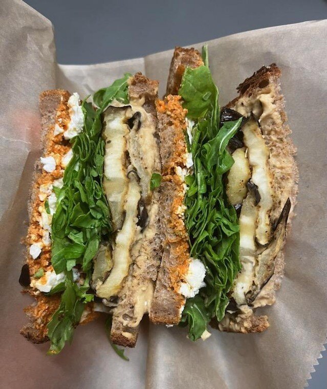 Roasted eggplant sandwich with za'atar roasted eggplant, hummus, romesco sauce, feta, mixed greens on toasted wheat. Available at Atticus Bookstore Cafe.