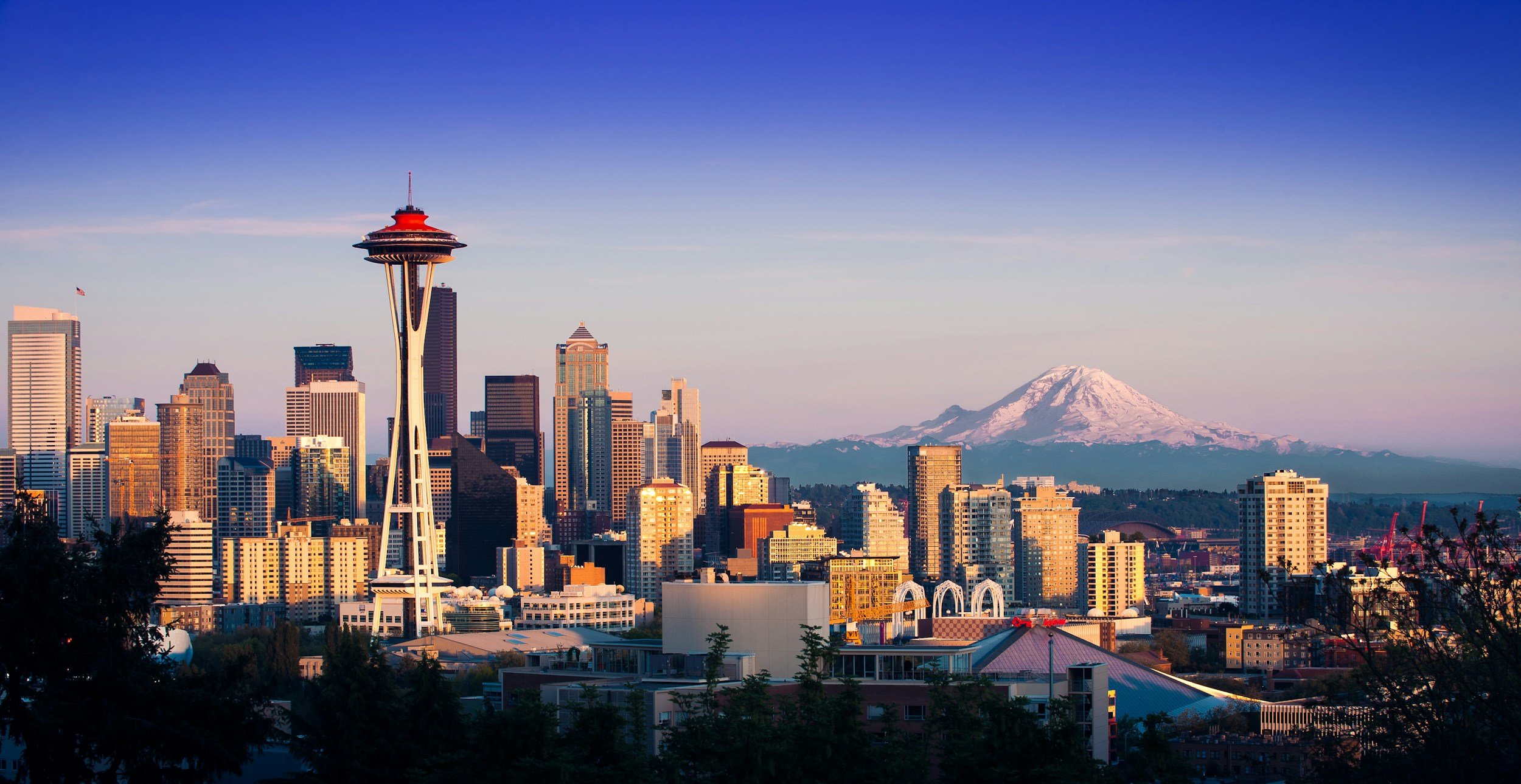 A photo of the Seattle skyline. The Space needle is prominent on the left side and Mt. Rainier is prominent on the right.