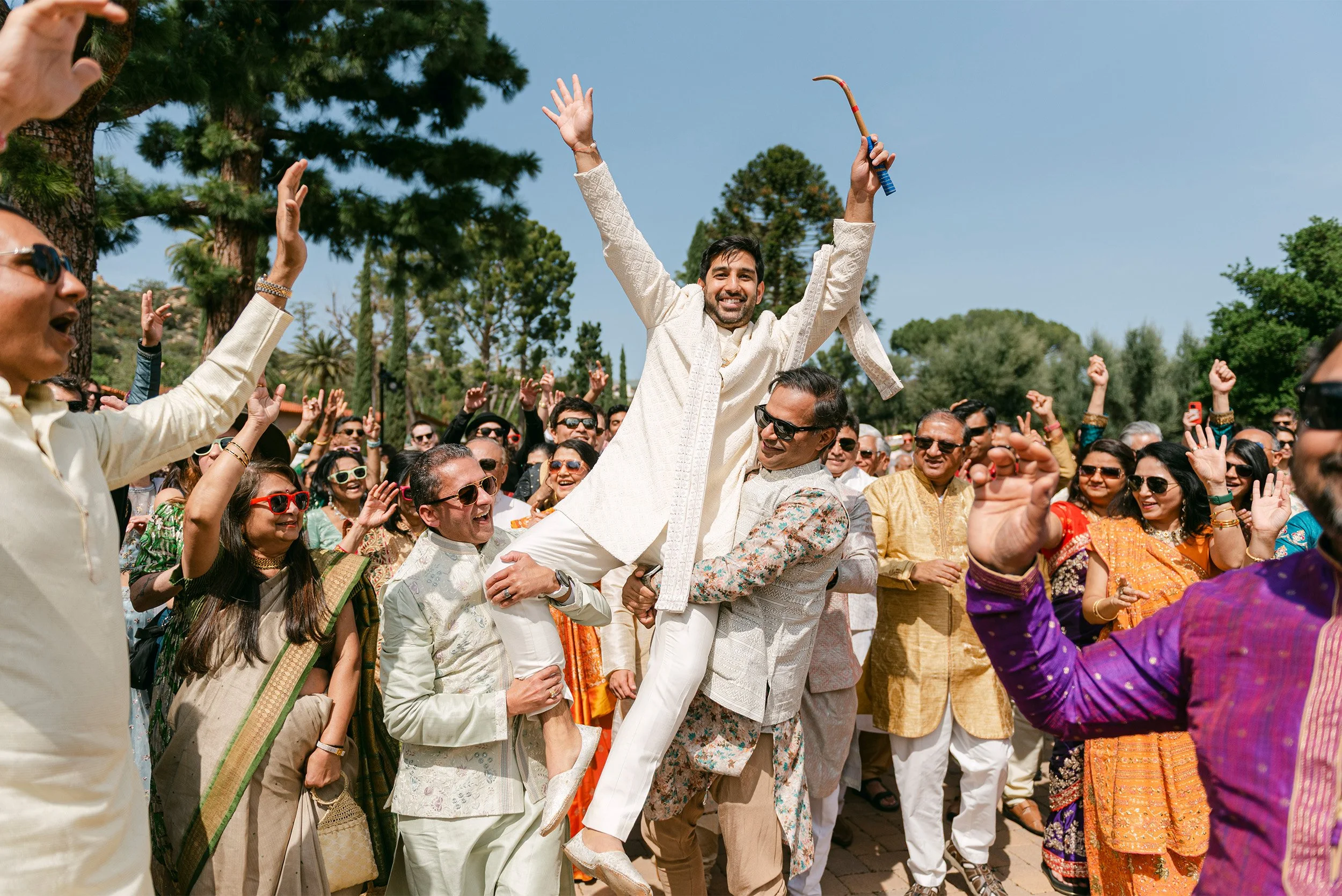 Groom lifted by groomsmen celebrating at Indian wedding, Orange County wedding photography
