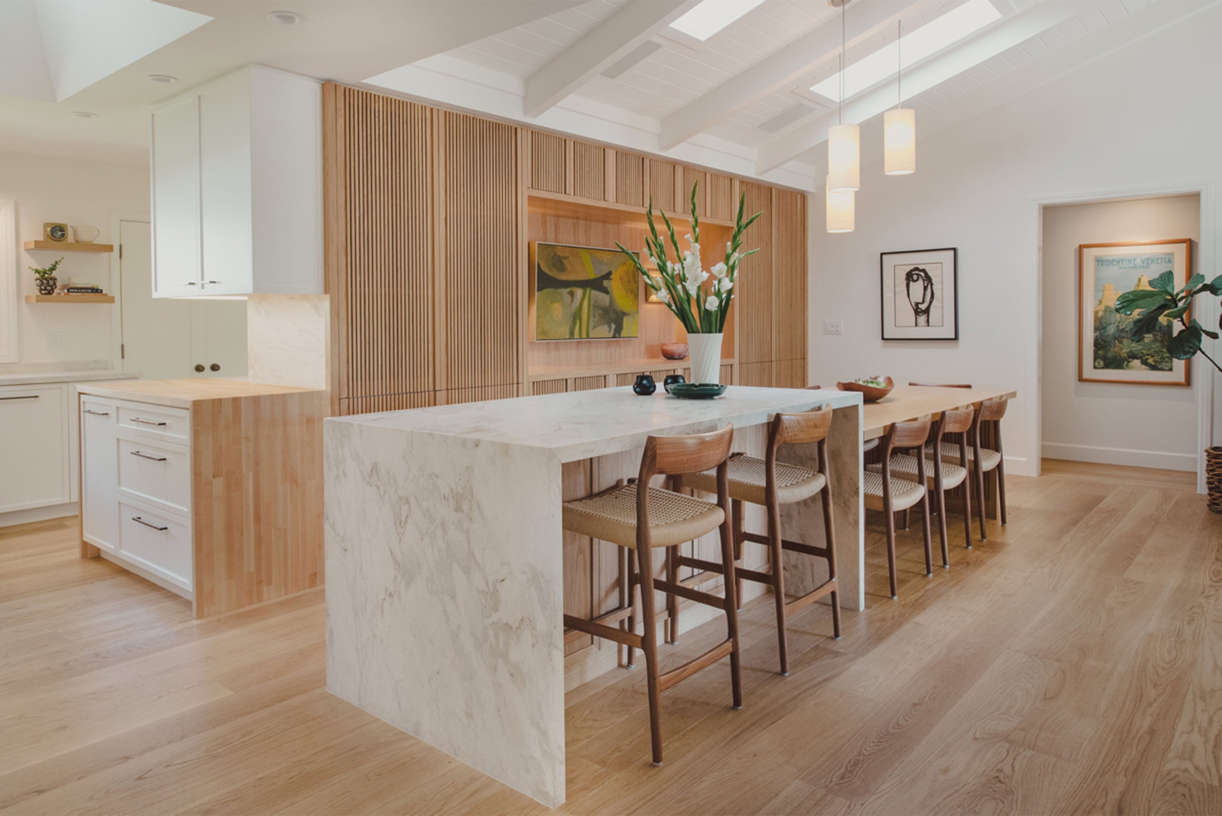 Interior design photography showcasing wood-slat kitchen wall and vaulted skylights in Southern California home, Orange County interior photographer