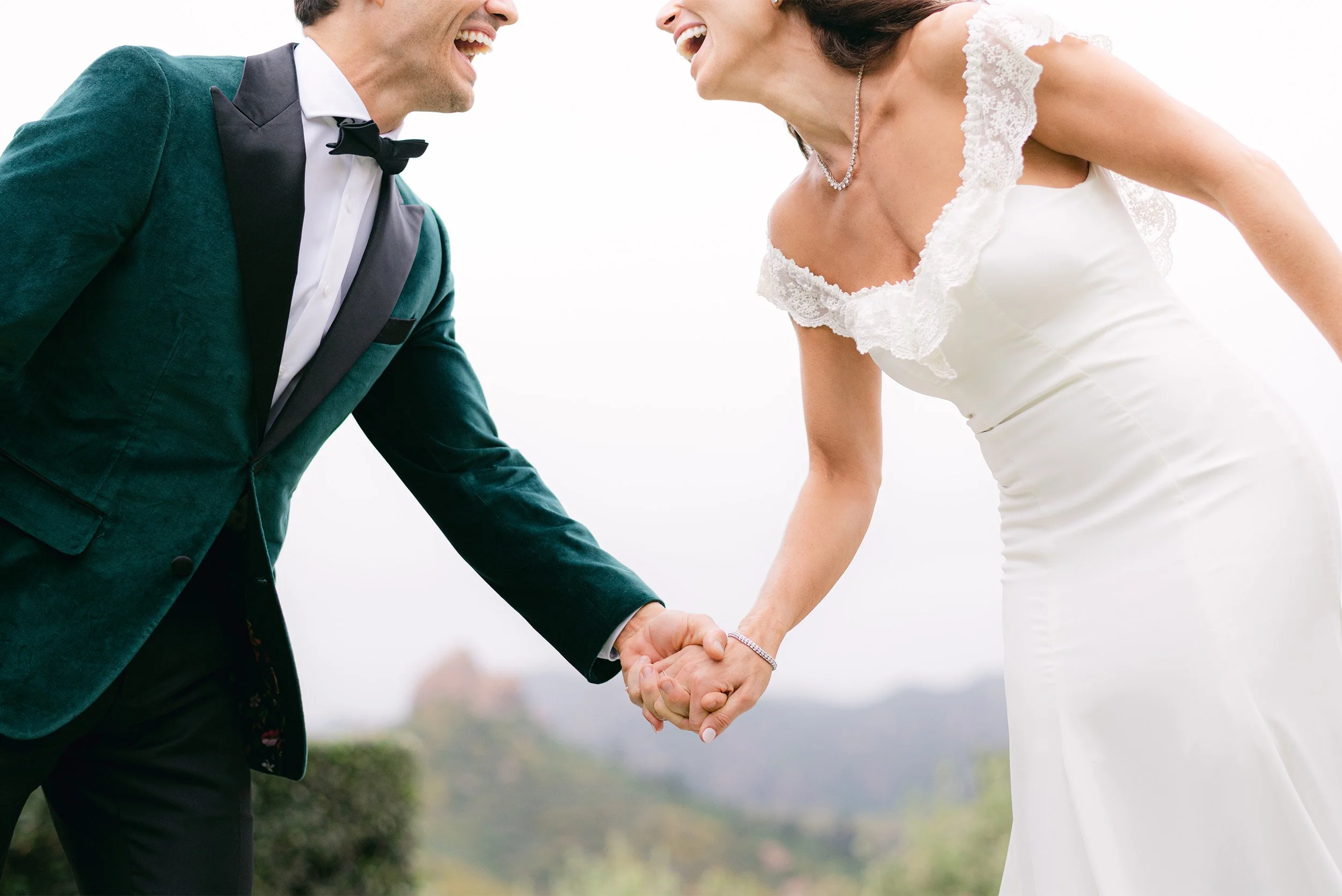 Orange County wedding photographer captures joyful close-up of bride and groom laughing while holding hands at Cielo Farms in Malibu wine country