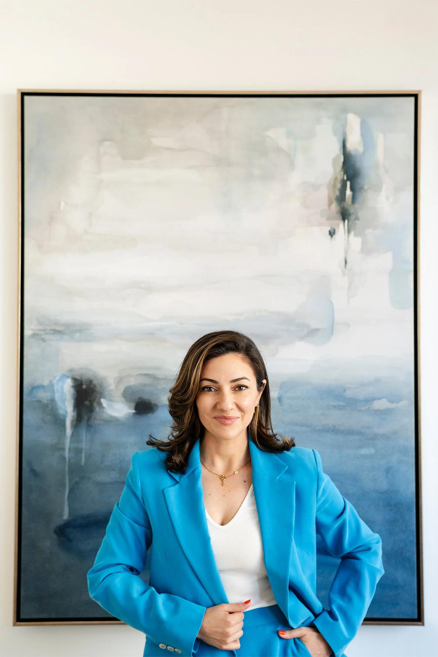 Award-winning corporate brand photographer in Orange County photographs executive headshot of Therapist with modern art backdrop Irvine
