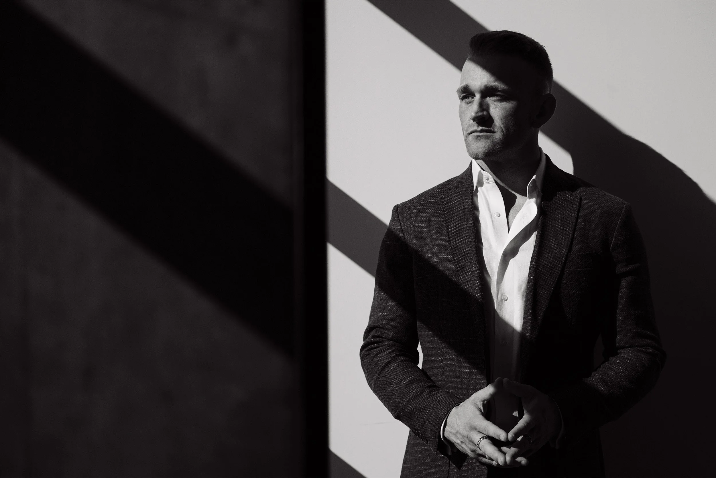 Highly recommended corporate photographer captures dramatic black-and-white executive portrait with graphic shadows