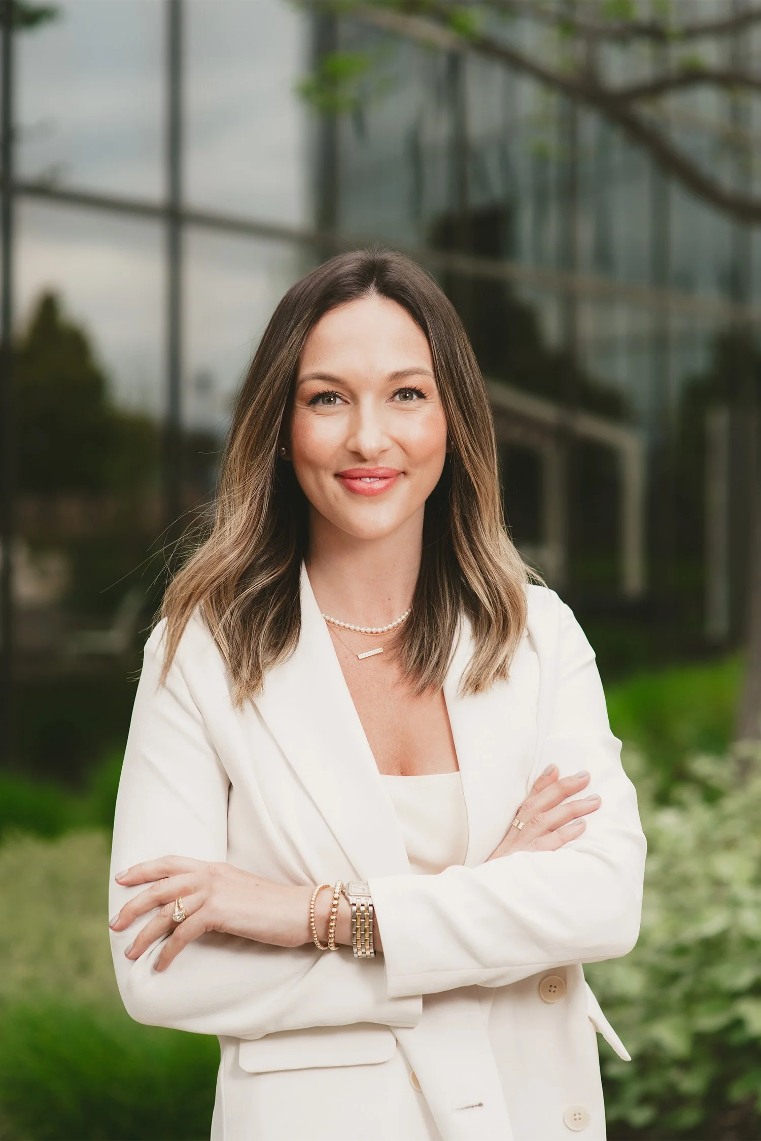 Orange County corporate photographer captures professional headshot of businesswoman outside glass office building