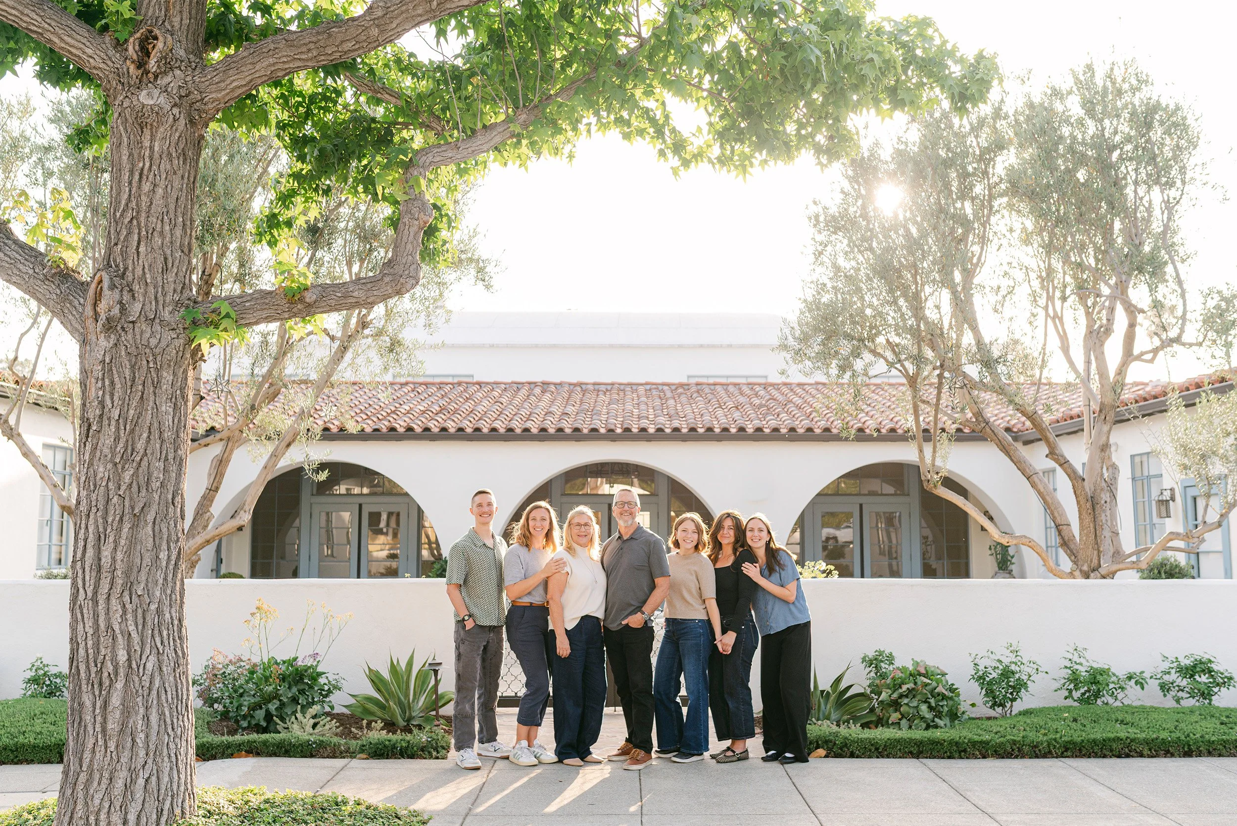 Award-winning business photographer captures multi-generation team portrait outside Spanish-style building in Old Towne Orange