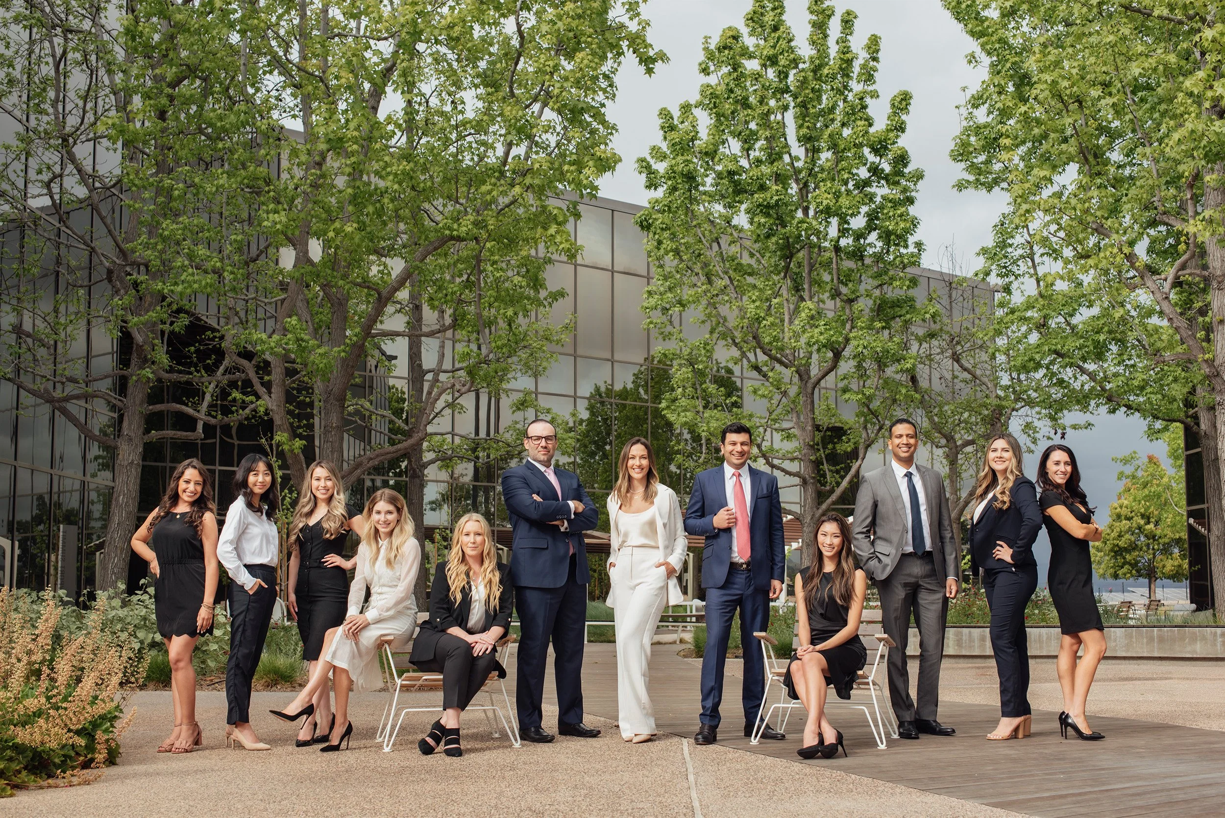 Highly recommended corporate photographer in Orange County captures RMD Law’s corporate team portrait outside modern glass office building, Irvine Lawyer Branding Photos