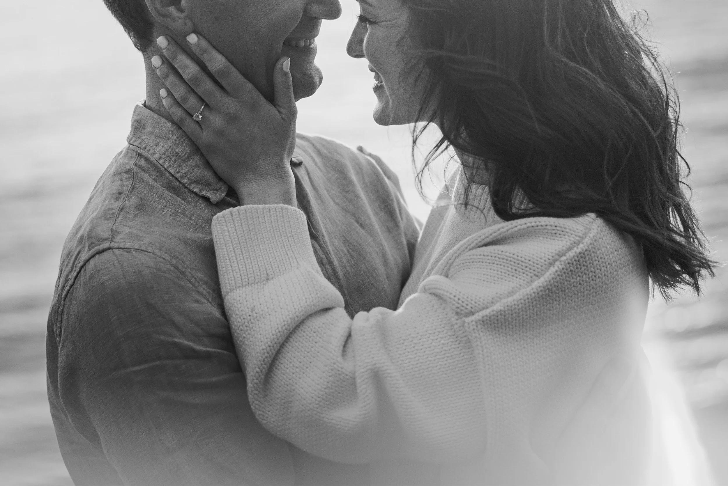 Santa Barbara engagement photographer captures candid black and white close-up of couple laughing together