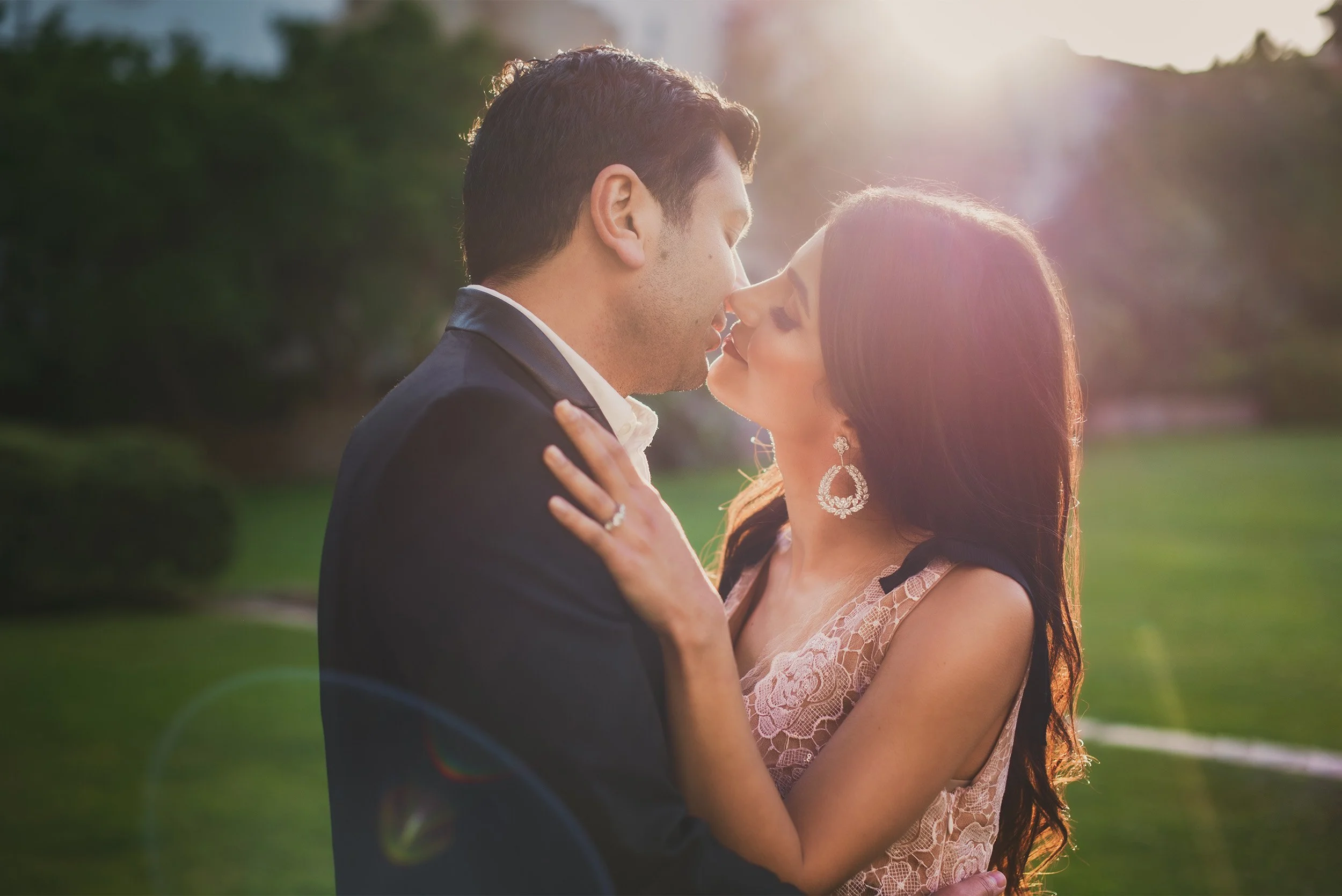 Close-up of couple about to kiss in golden hour light, romantic garden engagement portrait, Santa Barbara Courthouse Elopement