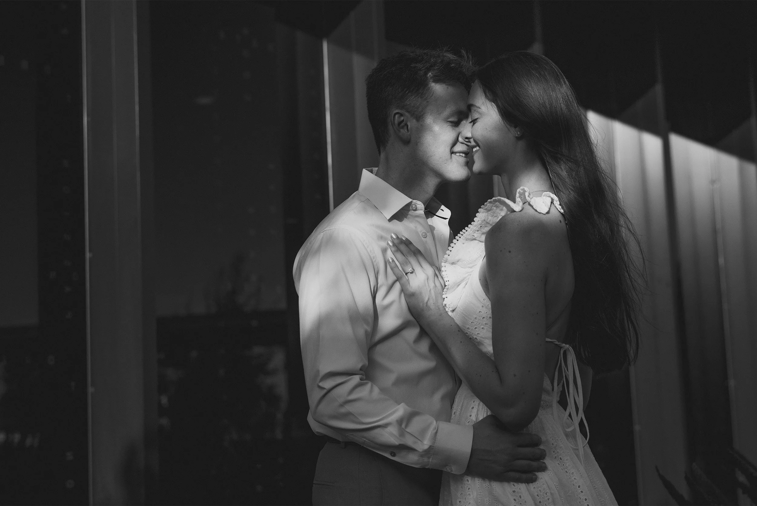 Highly recommended engagement photographer in Orange County captures intimate embrace between couple in candid black and white