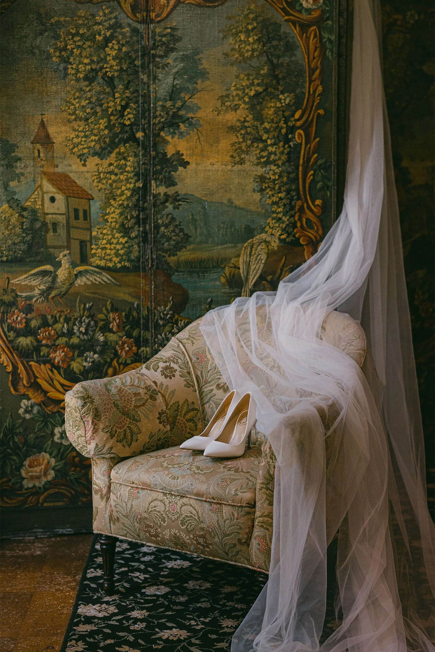 White wedding shoes and flowing veil draped over antique chair at The Ebell of Los Angeles, vintage-inspired bridal details