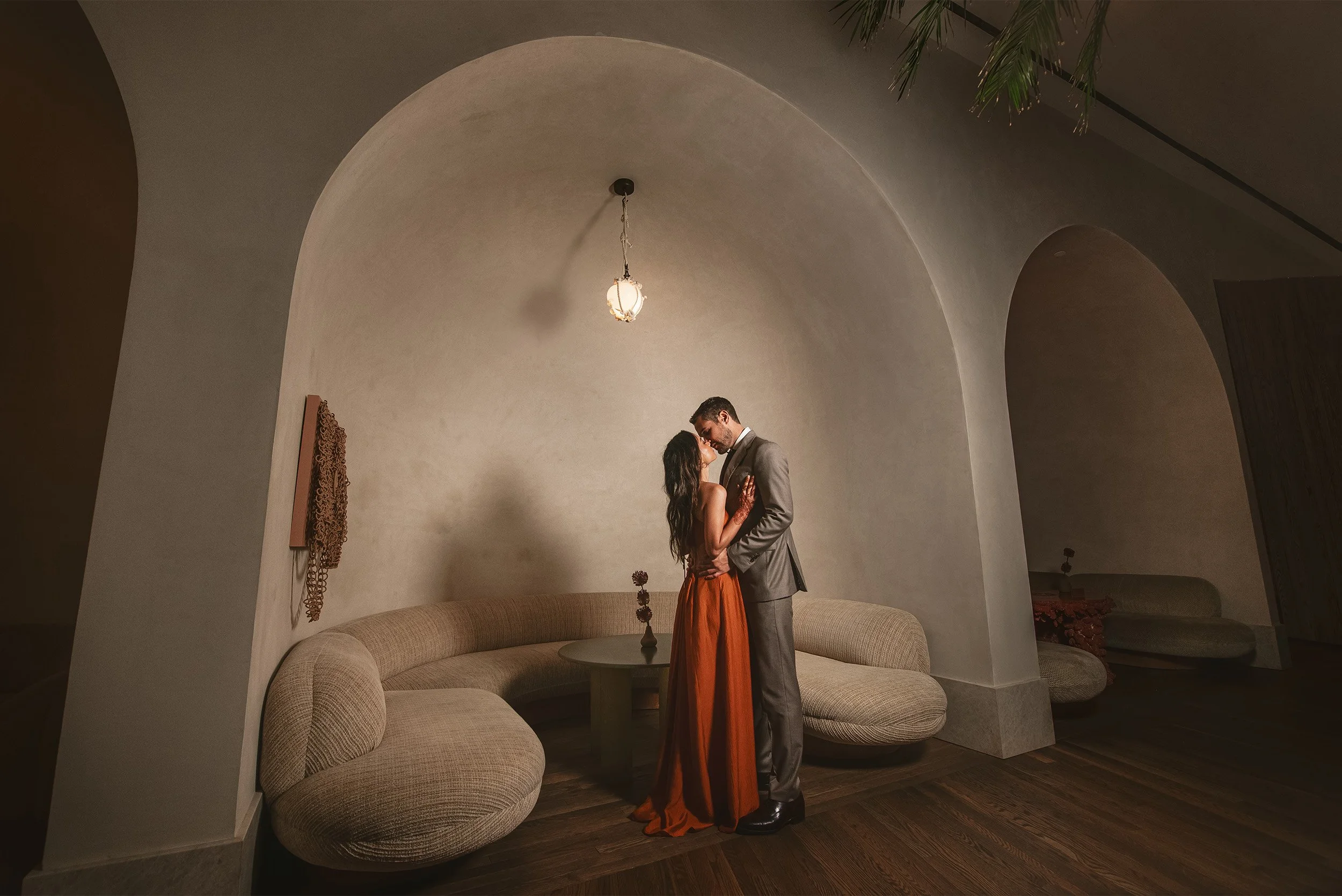 Bride and groom embracing under an archway in the  modern Spanish-style lounge at The Santa Monica Proper, Los Angeles engagement photography