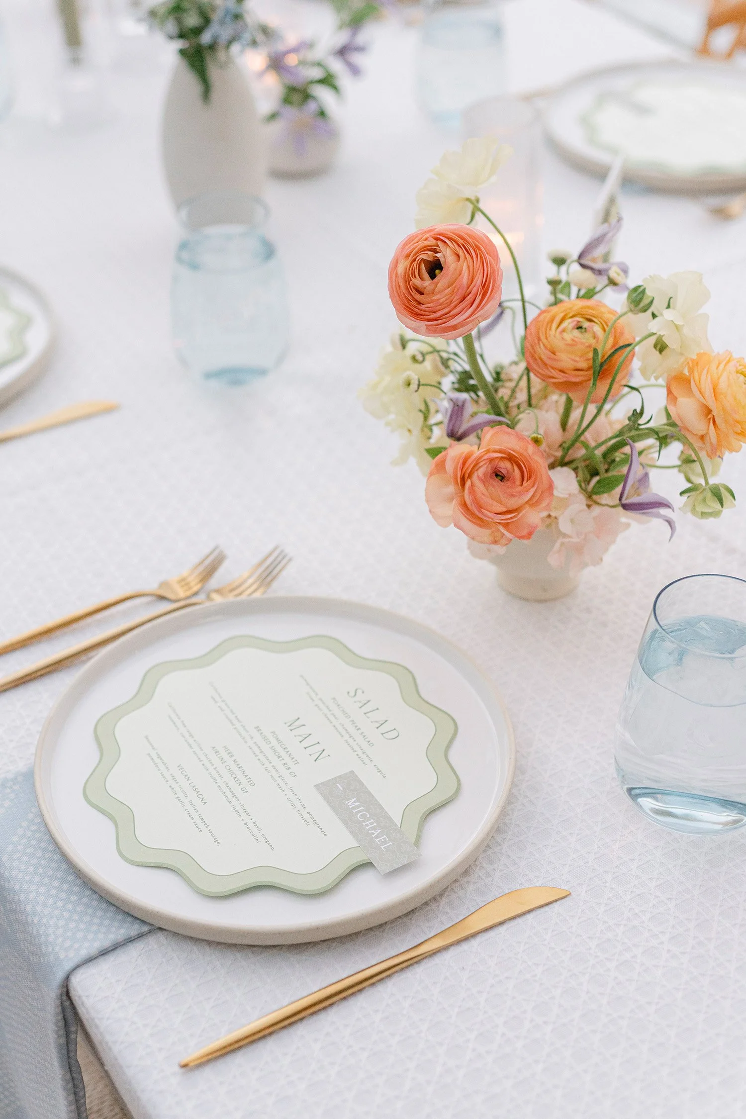 Orange County wedding photographer captures elegant reception place setting with peach ranunculus centerpiece and gold flatware, Casa Cody in Palm Springs
