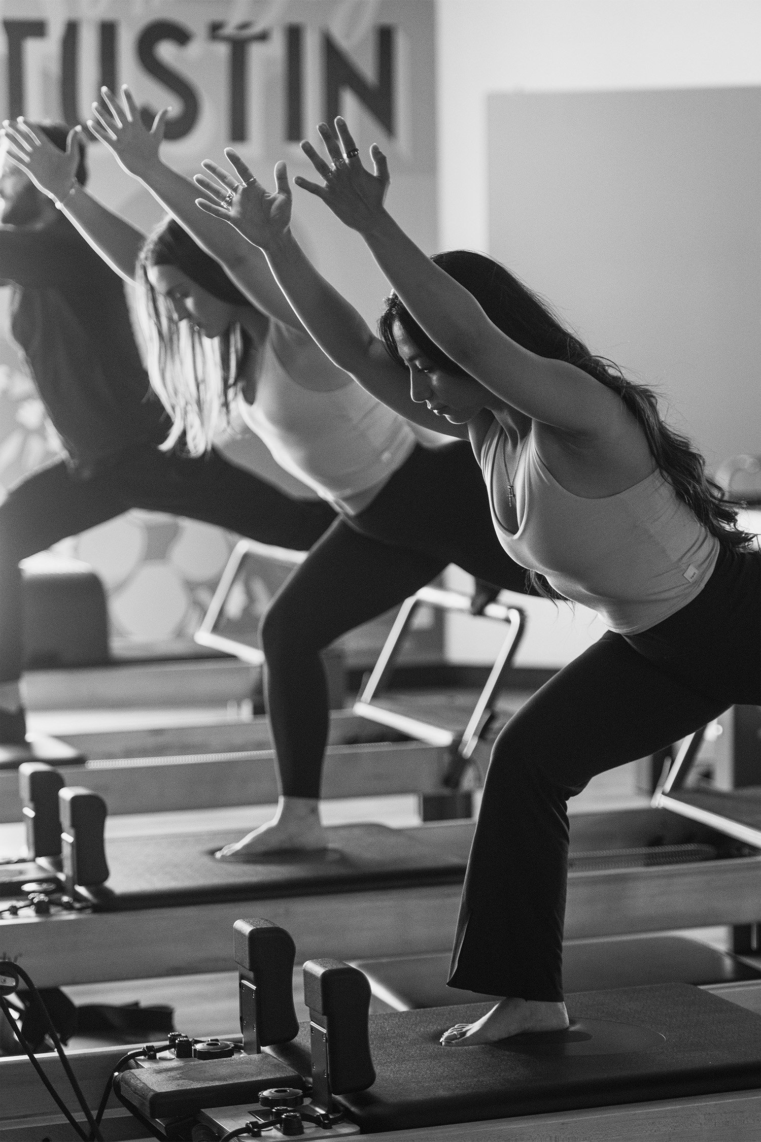 Award-winning brand photographer in Orange County captures dynamic black-and-white Pilates class in action