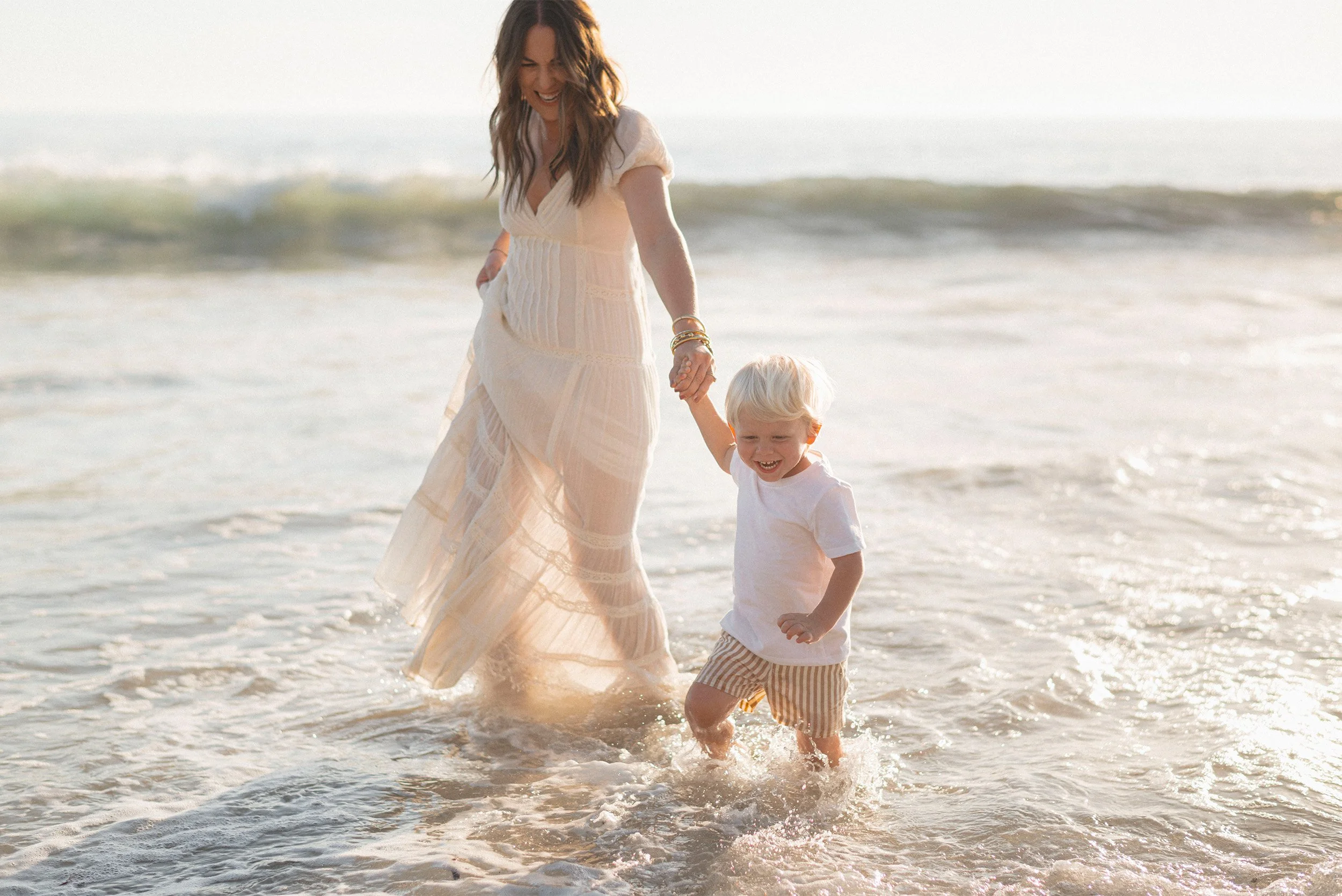 Award-winning family photographer in Orange County captures joyful mother-son moment in the Laguna Beach surf