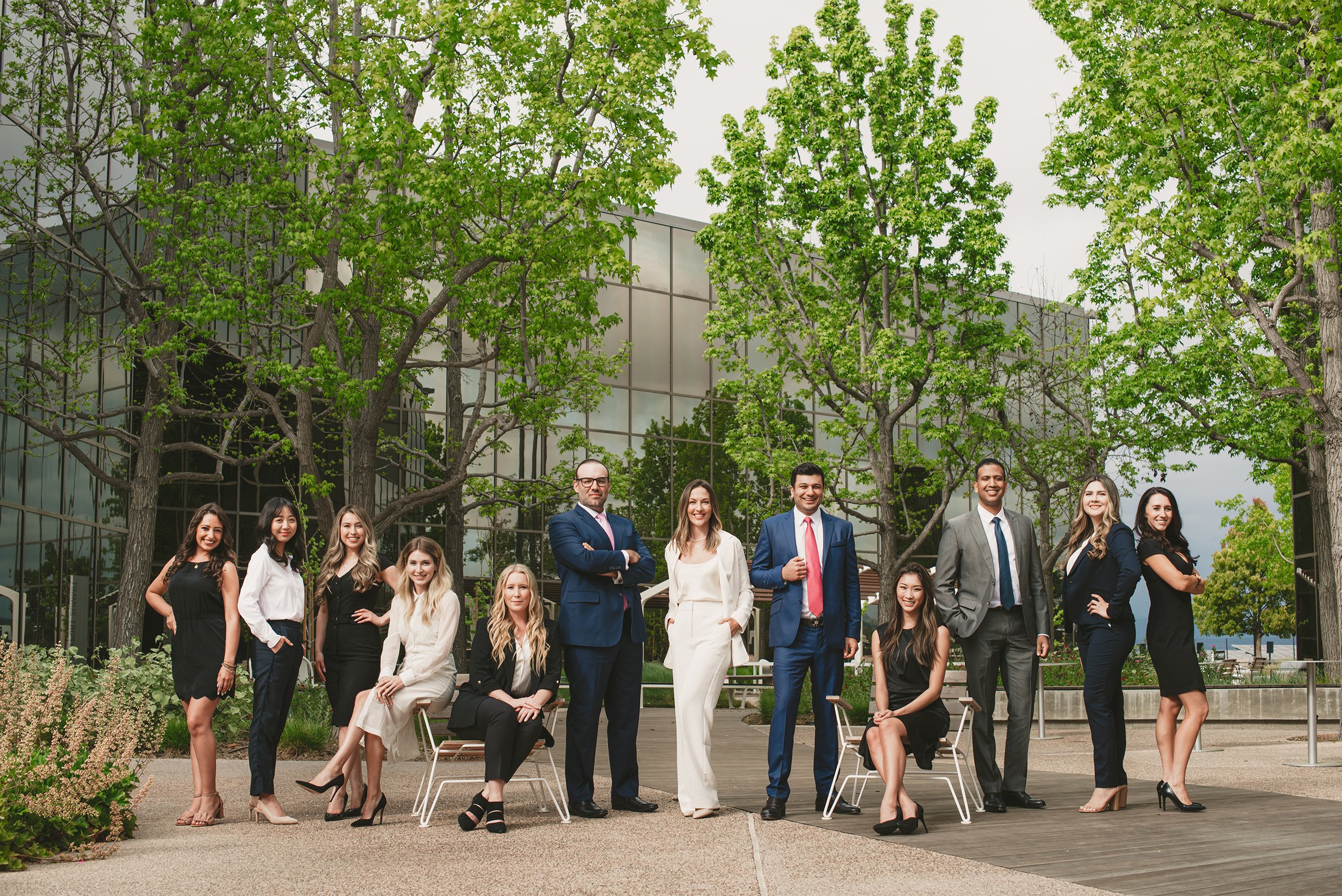Highly recommended corporate photographer in Oraneg County captures RMD Law’s corporate team portrait outside modern glass office building