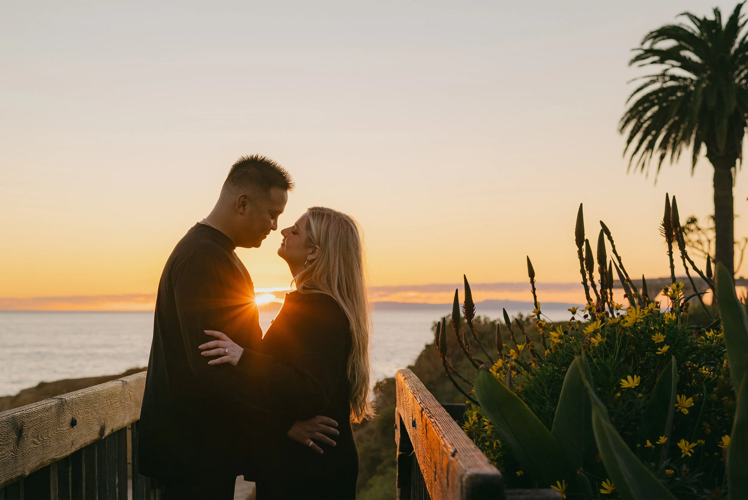 Highly recommended engagement in Orange County photographer captures couple embracing at sunset above the Laguna Beach coastline at The Montage