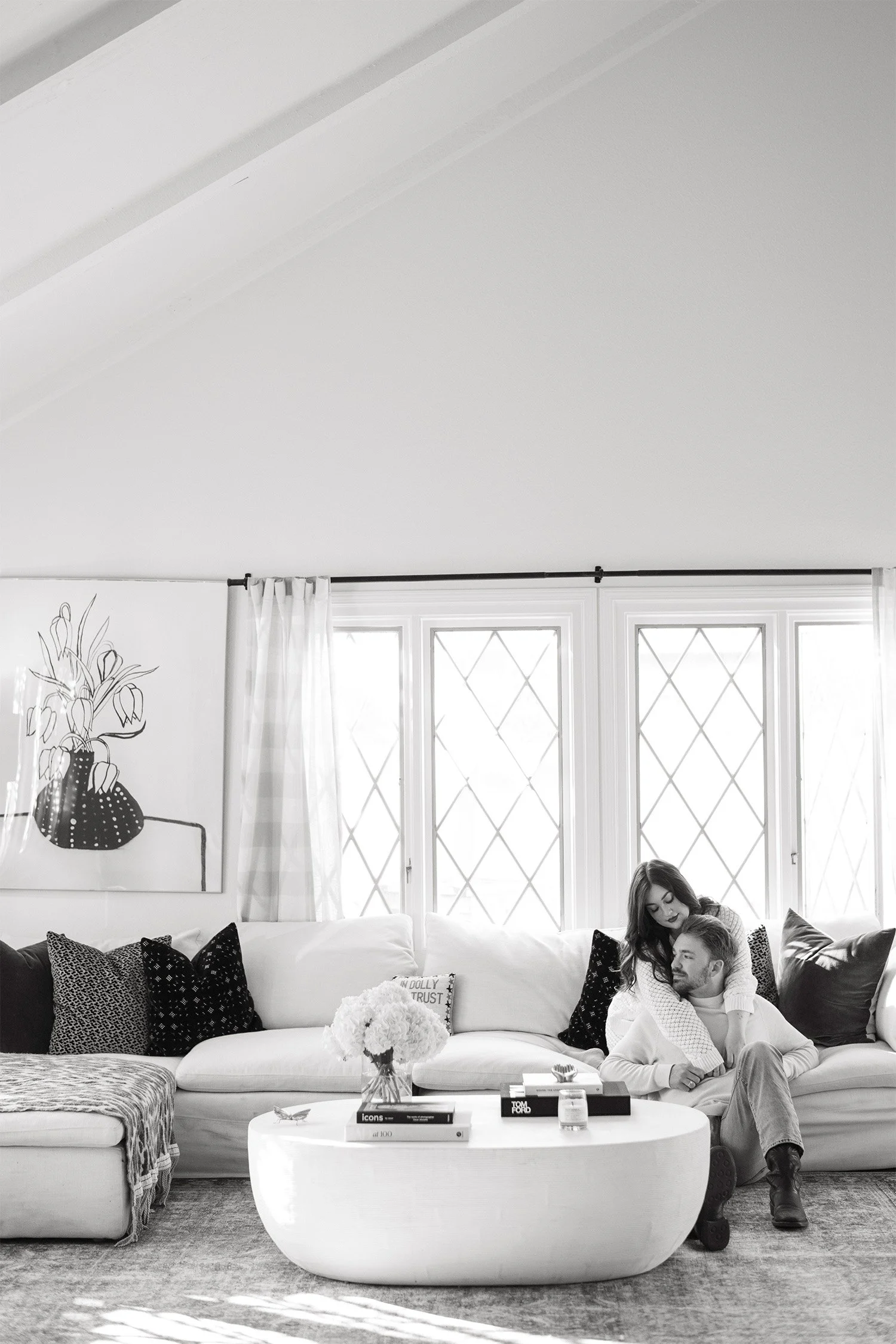 Orange County engagement photographer captures couple relaxing together in bright living room session, in home engagement session