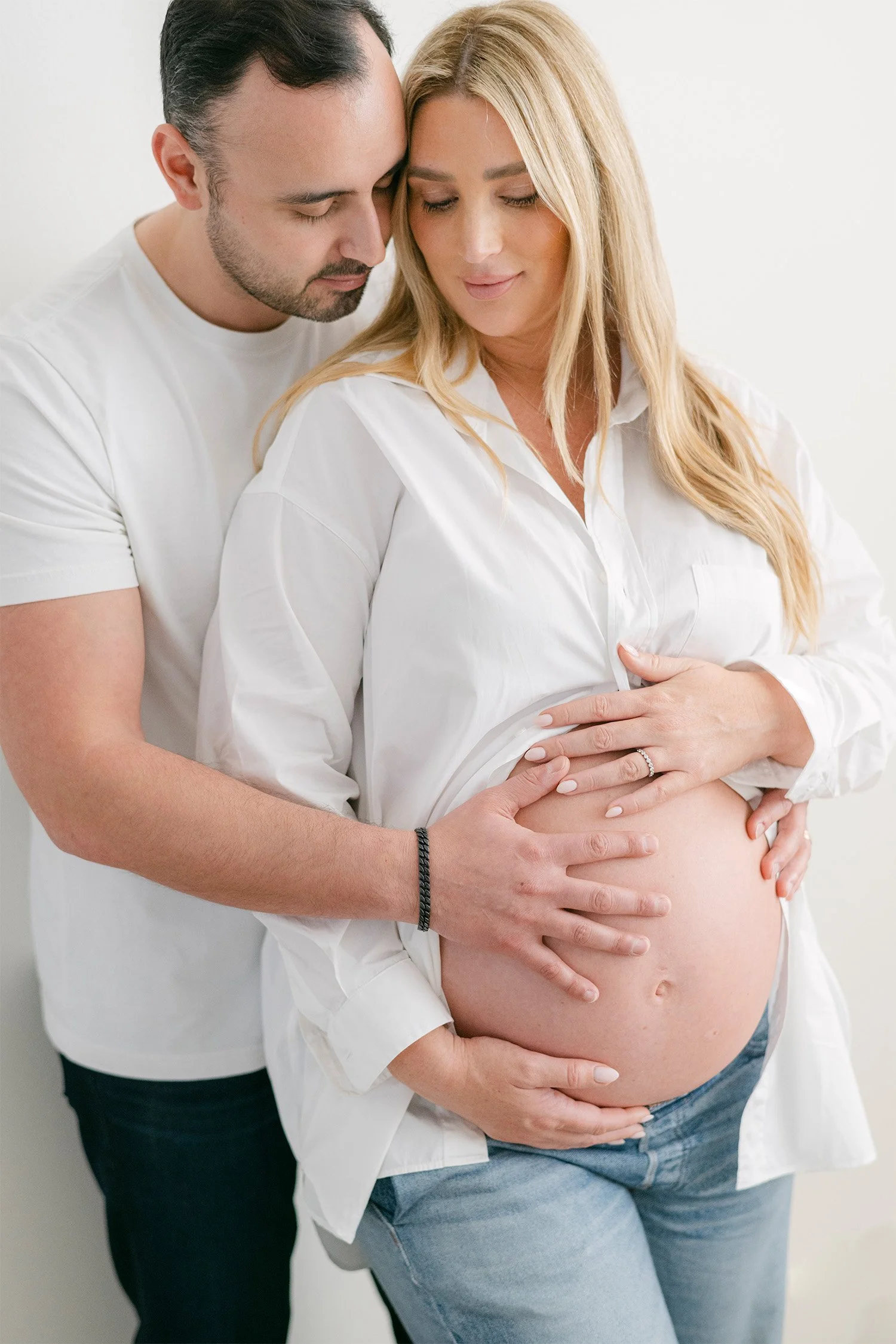 Husband embracing pregnant wife's belly, Orange County maternity photographer