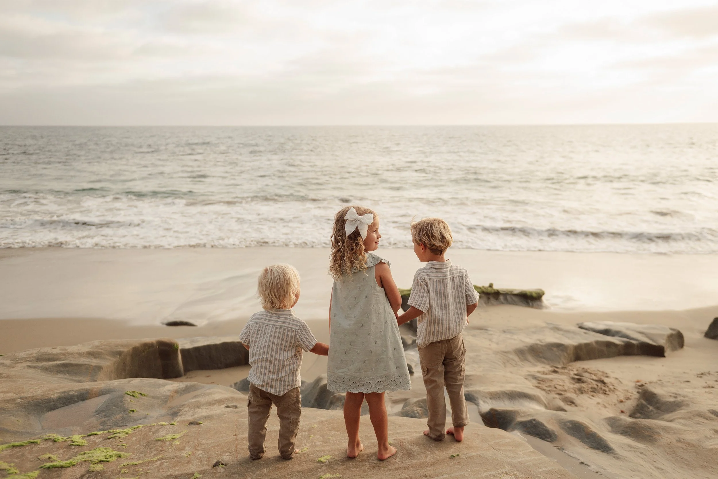 Orange County family photographer captures siblings gazing out at the ocean together in Laguna Beach