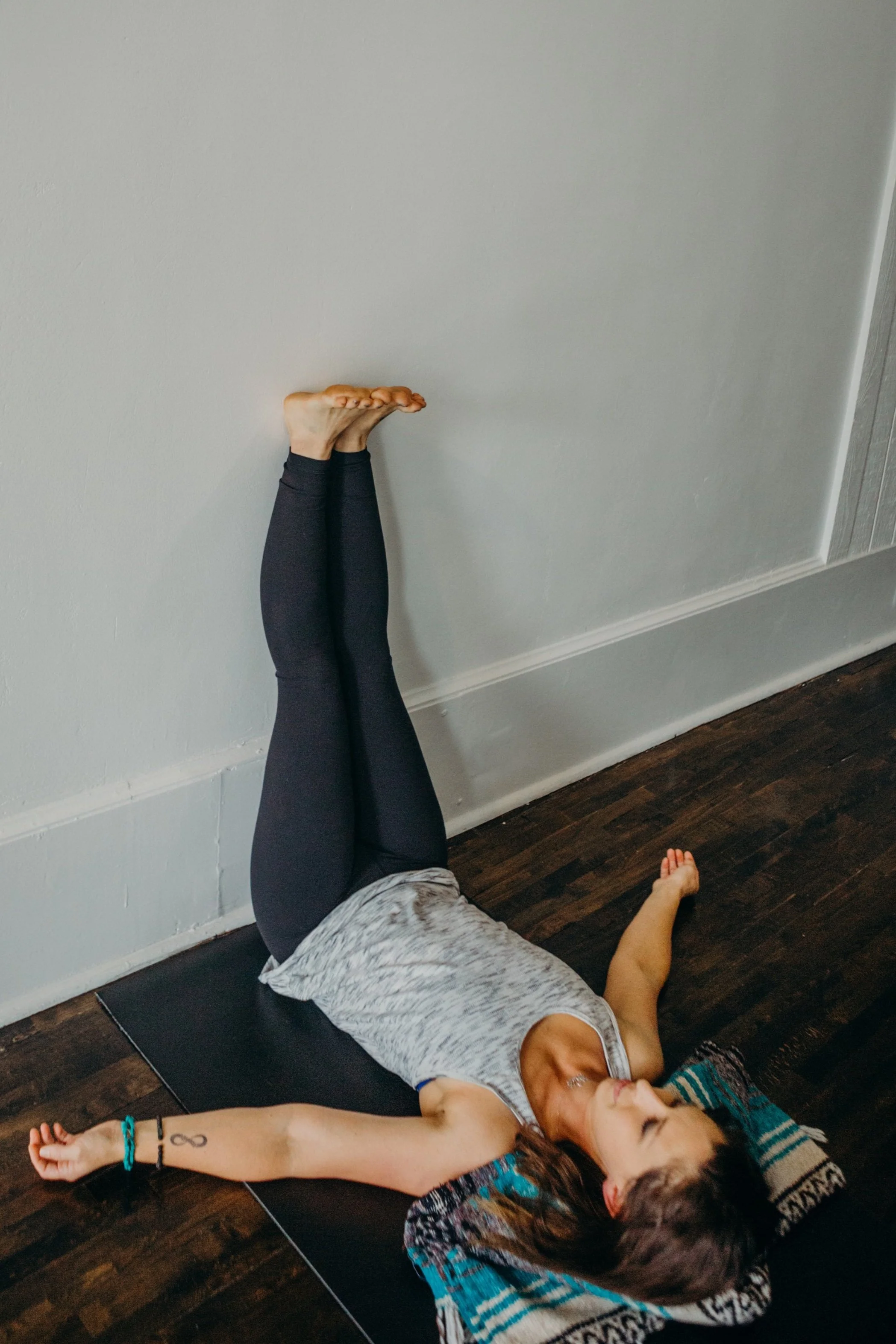 Person practicing yoga with legs up the wall