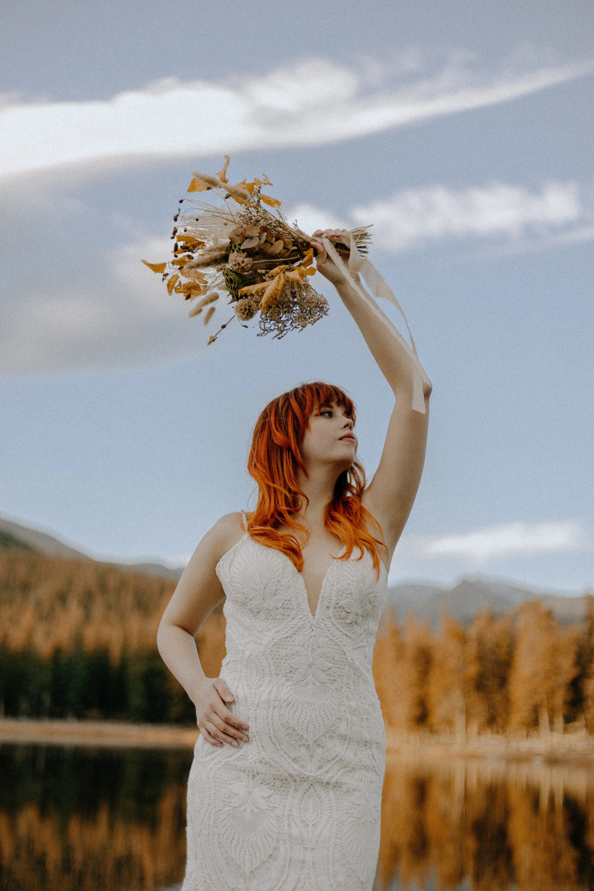 Houston & Texas Wedding & Elopement Photography – Bride holding flowers up to sky at Echo Lake Colorado fall elopement.