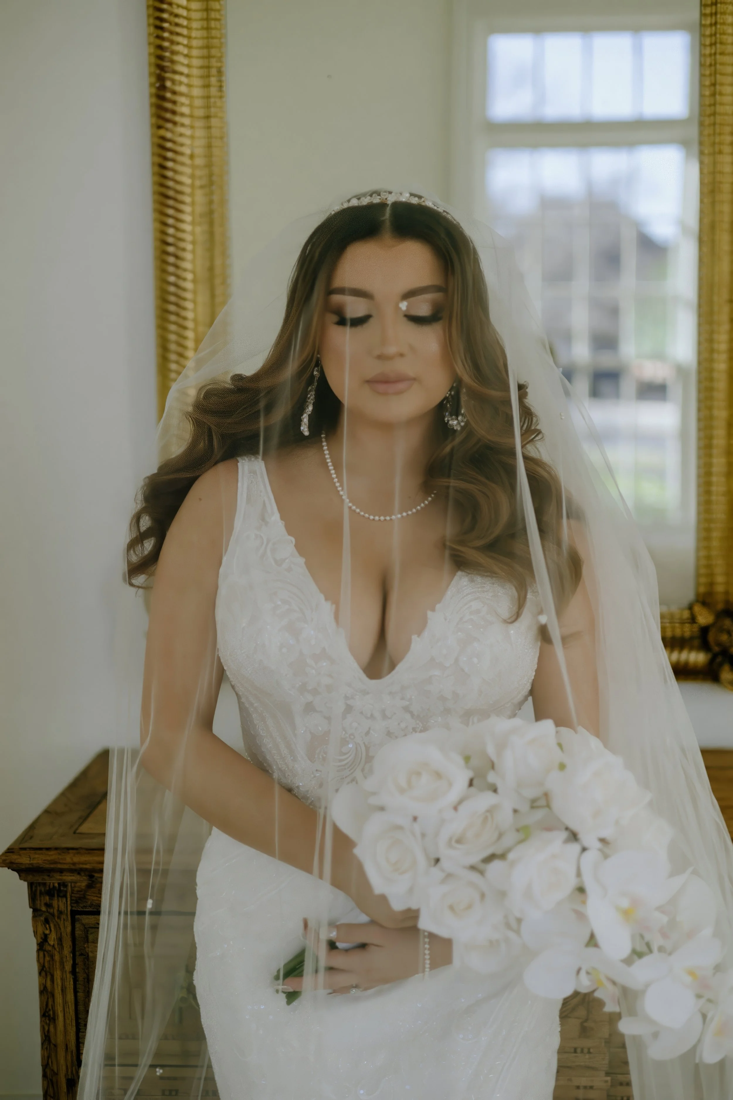 Houston & Texas Family, Couples, Newborn, Maternity, Bridal Photography – Bride holding bouquet in front of fireplace, Houston studio.