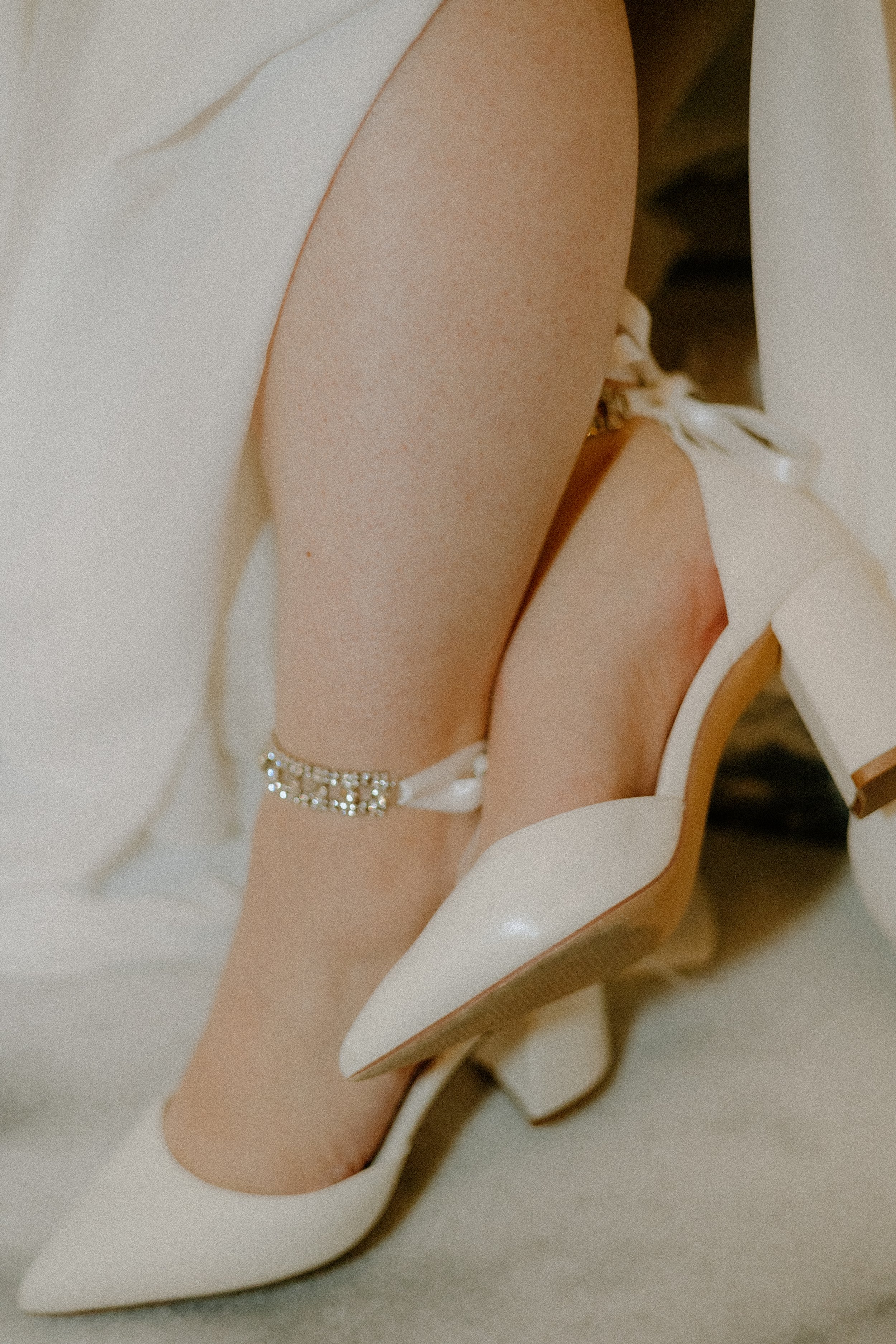Texas Elopement Photography – close-up of bride’s heels and ankle bracelet on courthouse marble floor