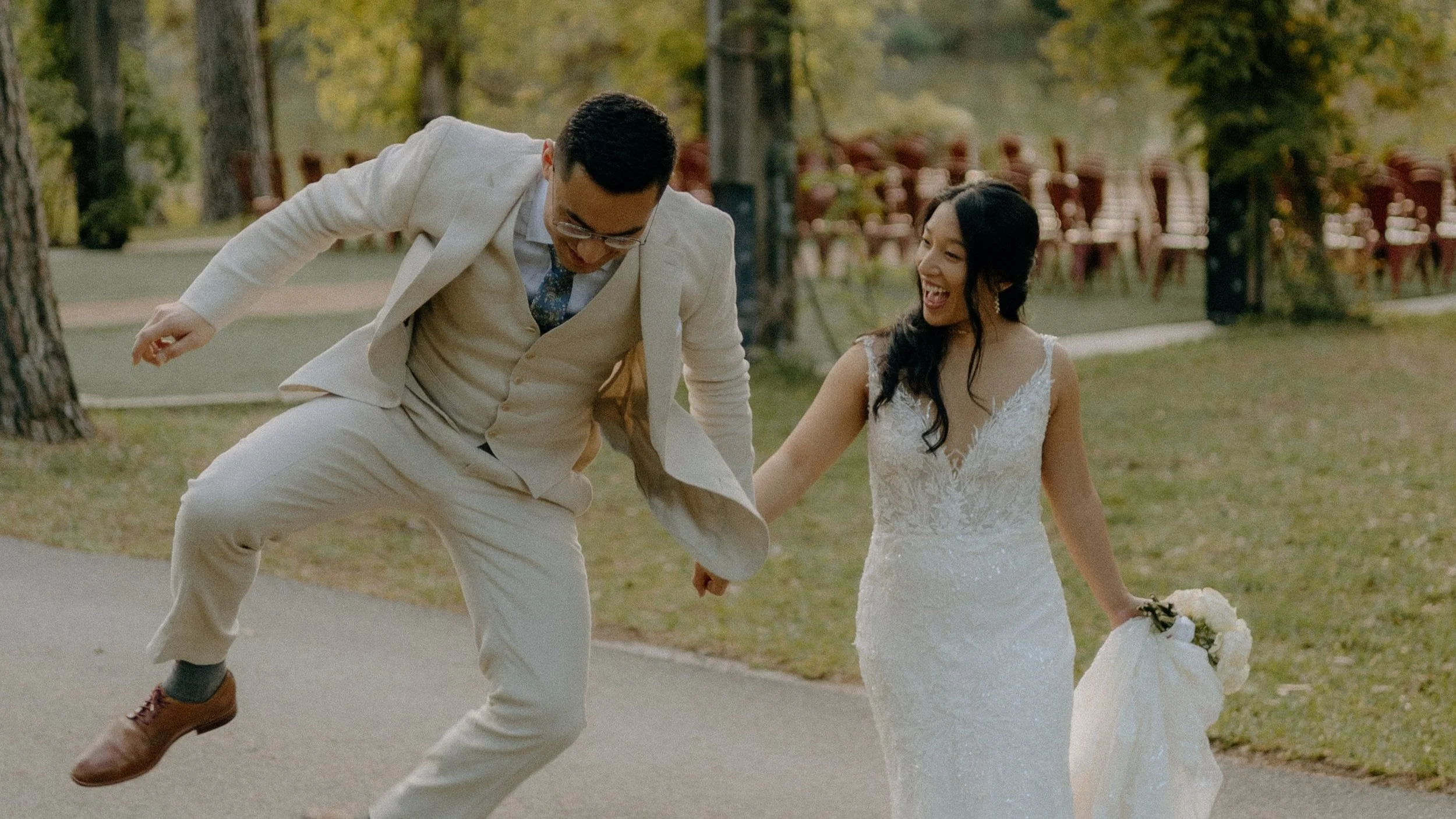 Golden Hour Wedding Venue, Houston TX – joyful couple with their dog walking through tree-lined pathway at Forever 5 Events during golden hour