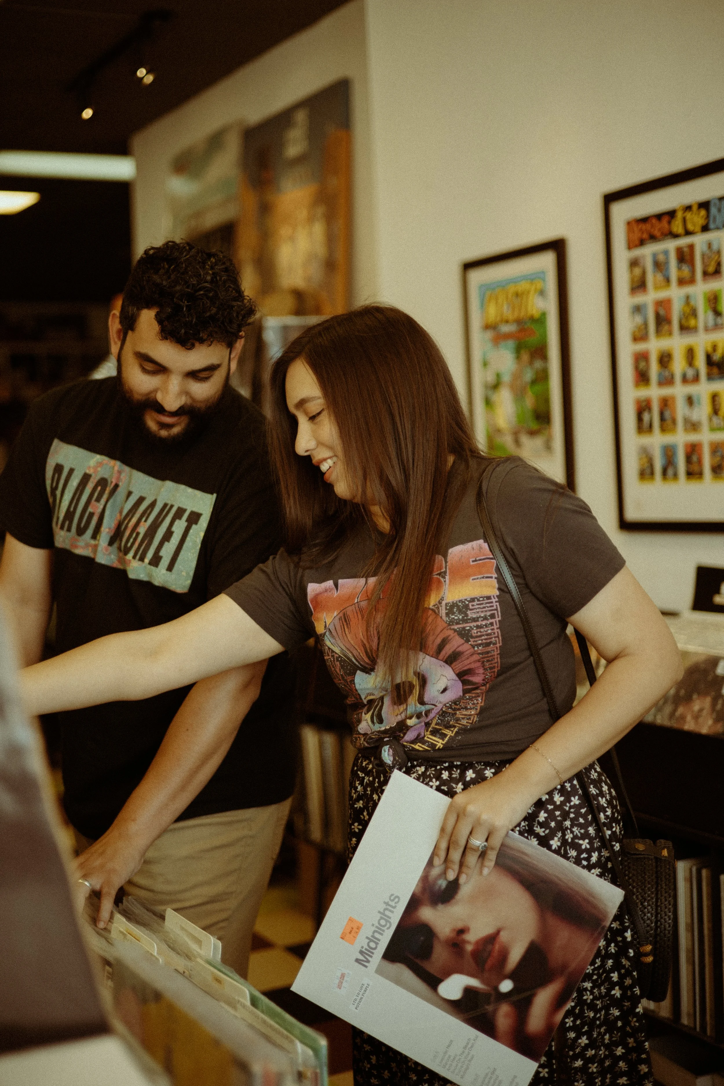 Couples Portrait Photography, Houston TX – candid laugh between couple while holding records and browsing
