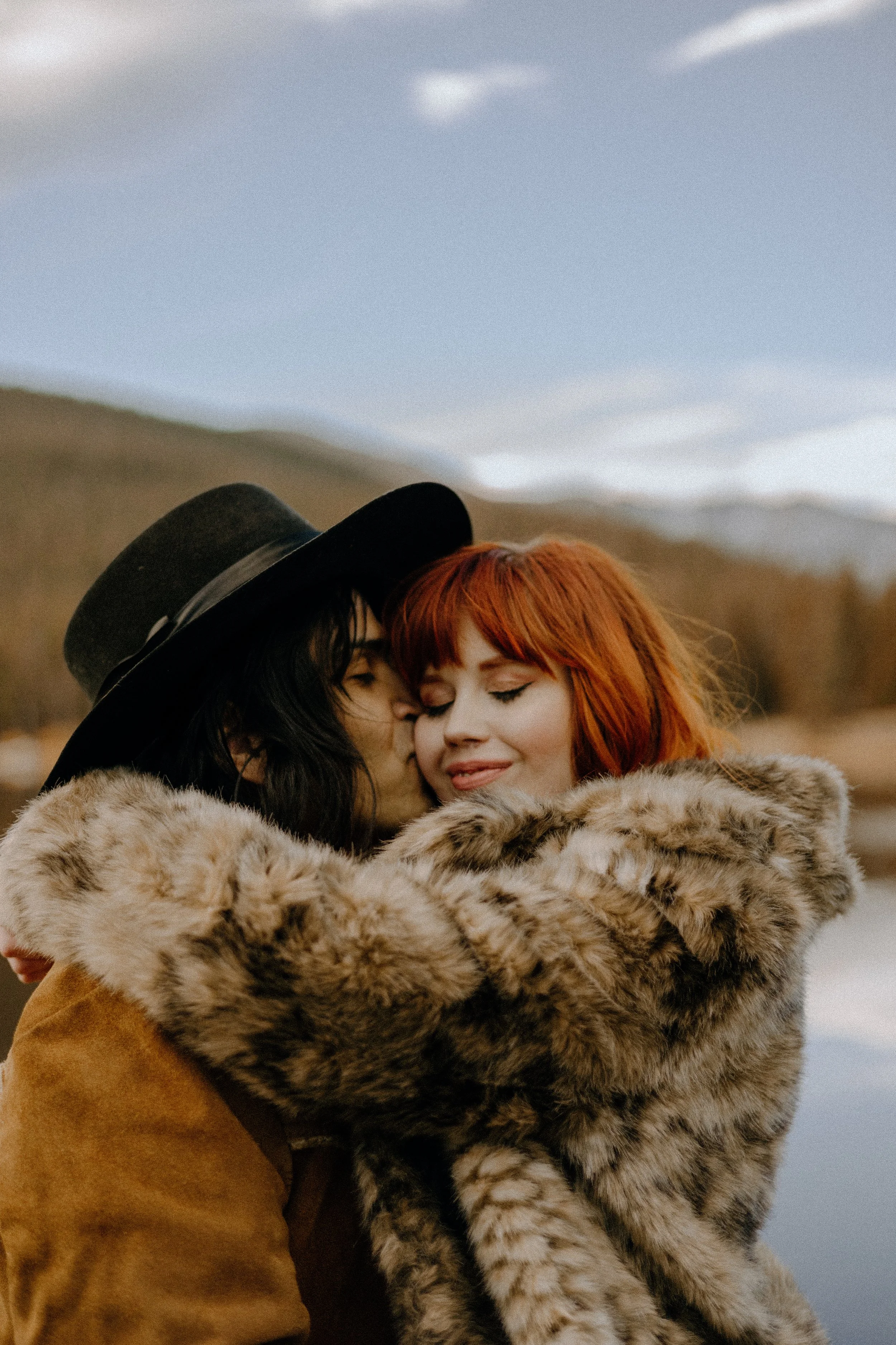 Houston & Texas Wedding & Elopement Photography – Groom hugging bride in fur wrap at Echo Lake Colorado elopement.