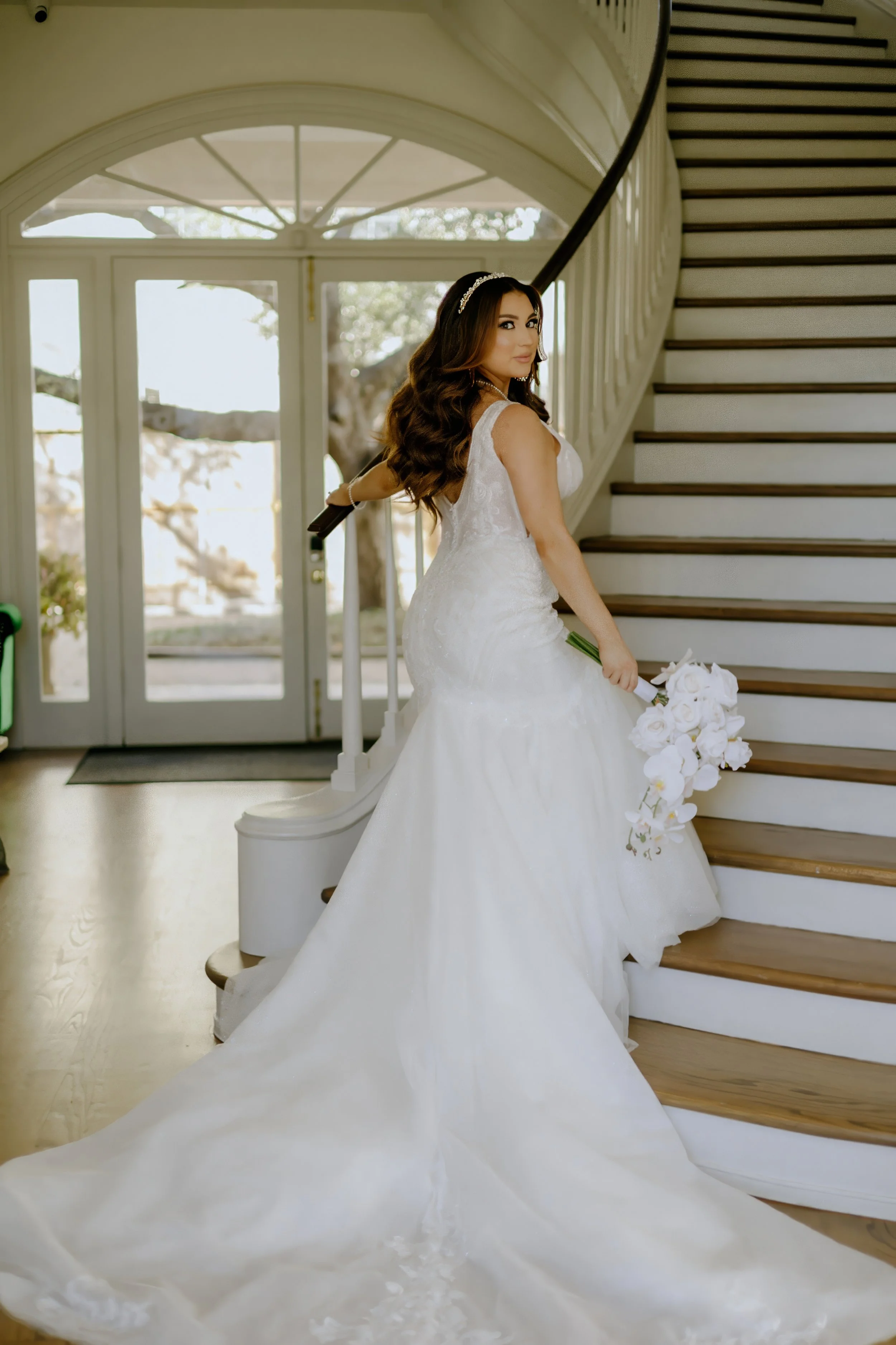 Houston & Texas Family, Couples, Newborn, Maternity, Bridal Photography – Bride seated on staircase with cascading gown, Houston studio.