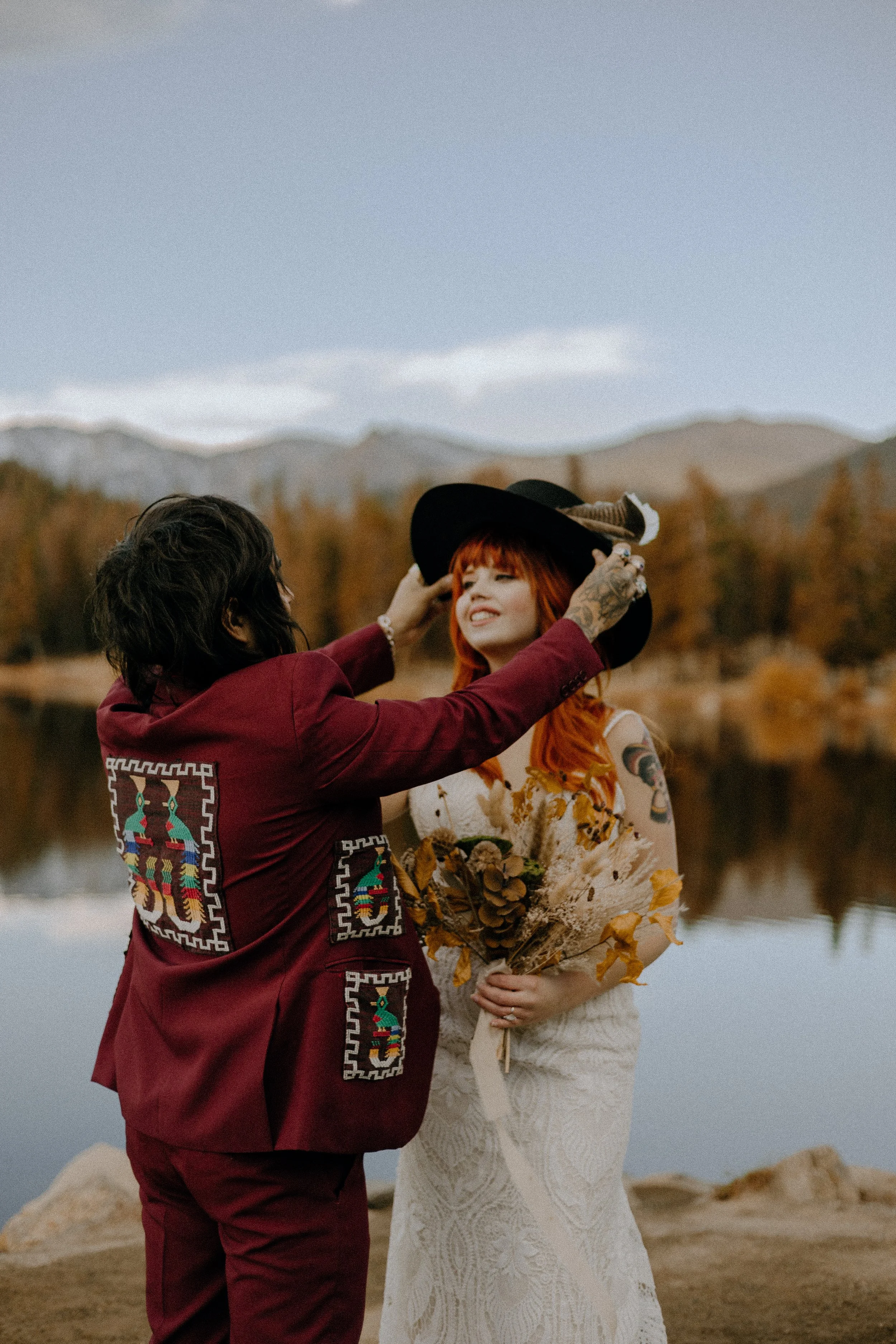 Houston & Texas Wedding & Elopement Photography – Groom adjusting bride’s hat near Echo Lake Colorado elopement.