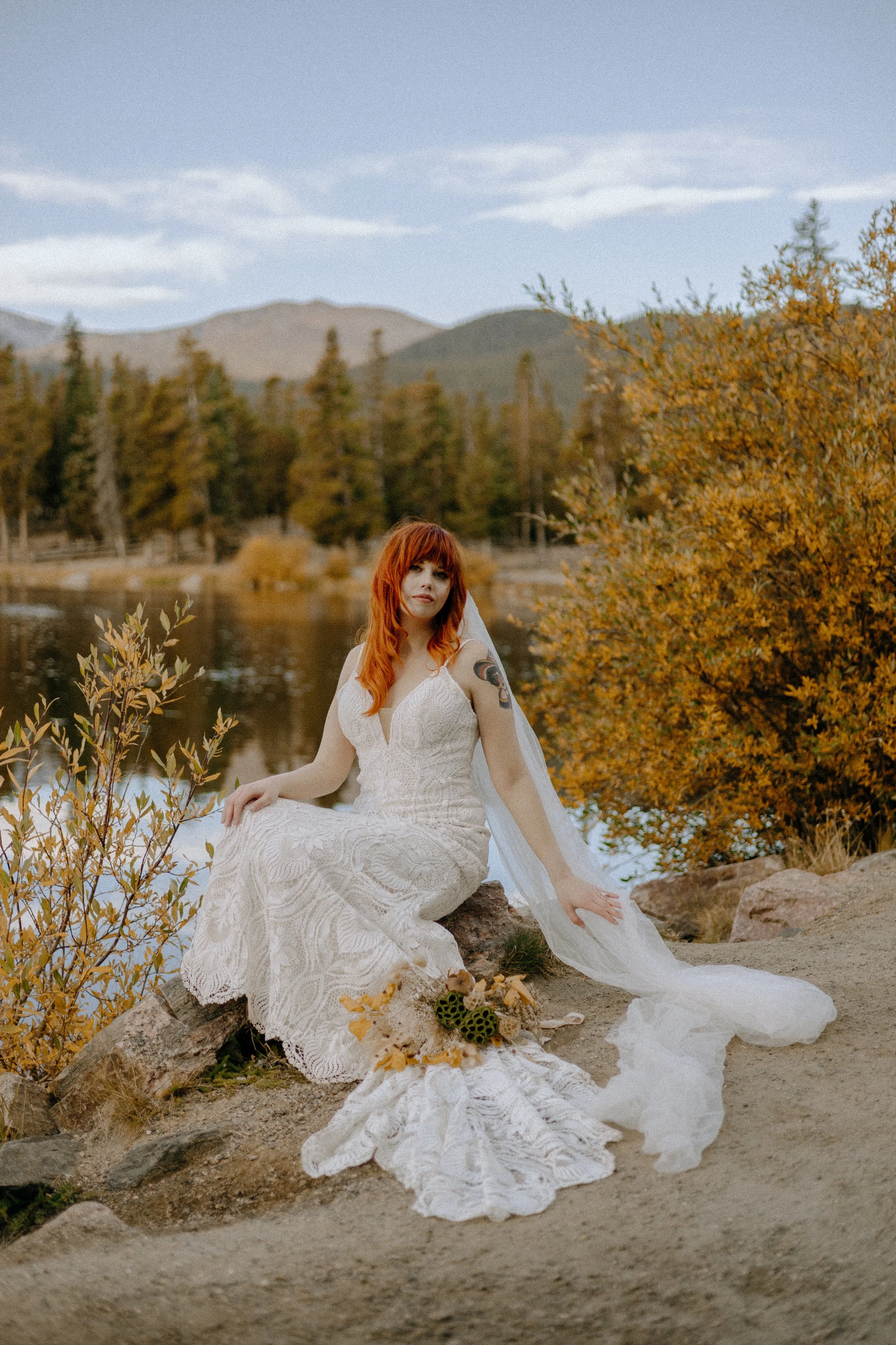 Houston & Texas Wedding & Elopement Photography – Bride seated outdoors with lace gown in fall near Echo Lake Colorado.