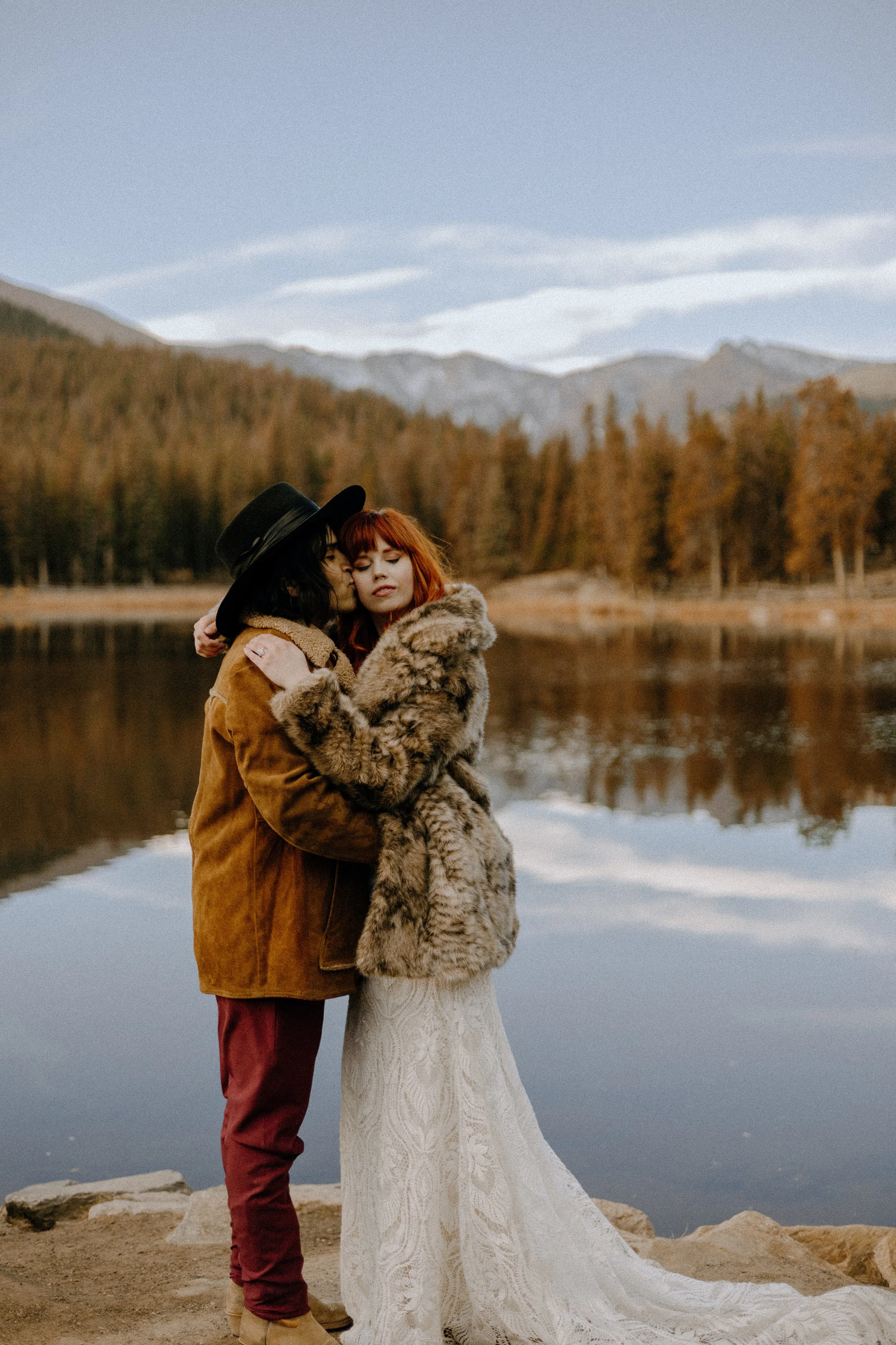 Houston & Texas Wedding & Elopement Photography – Groom embracing bride by mountain lake in Echo Lake Colorado.