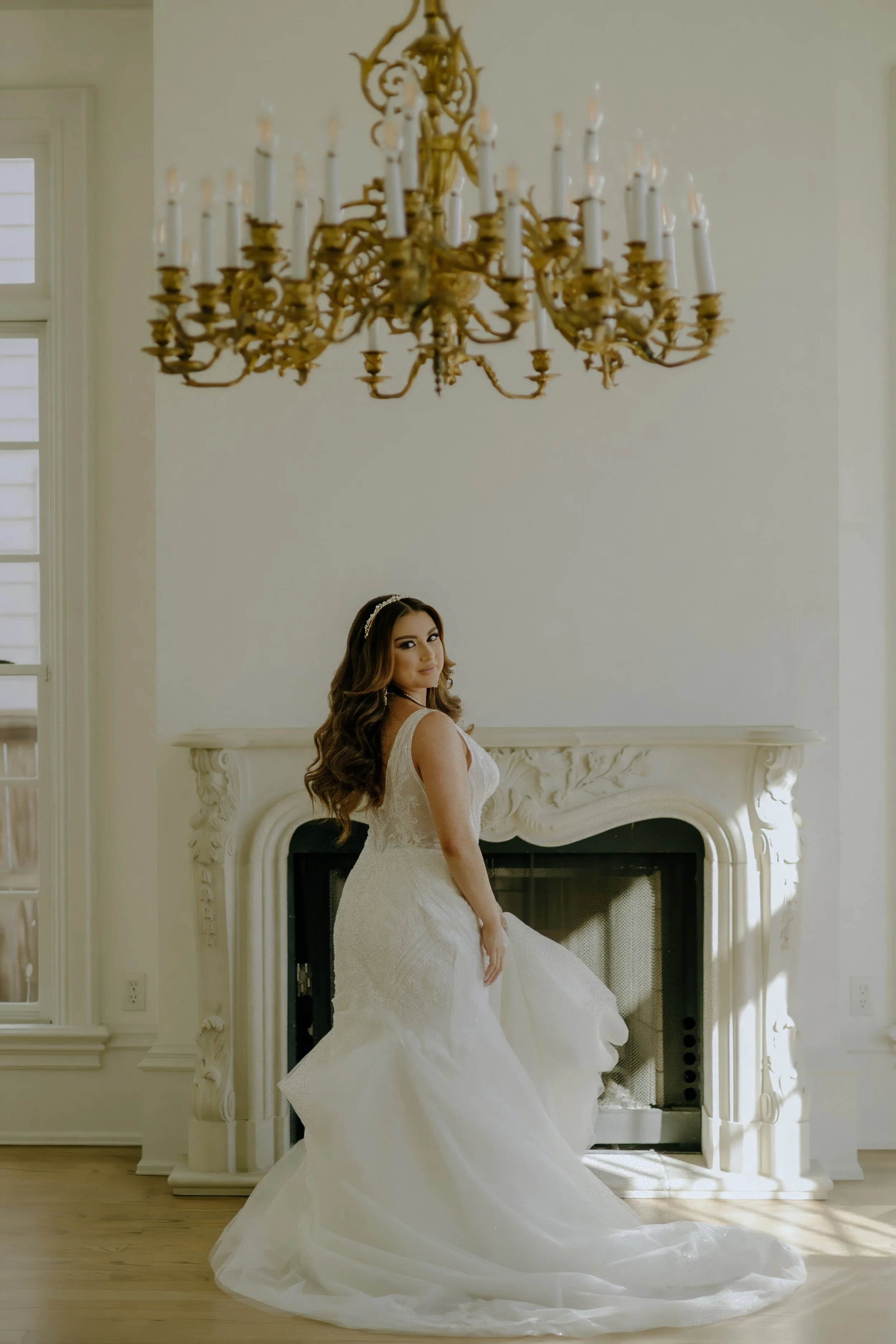 Houston & Texas Family, Couples, Newborn, Maternity, Bridal Photography – Bride posing with elegance under ornate chandelier, Houston.