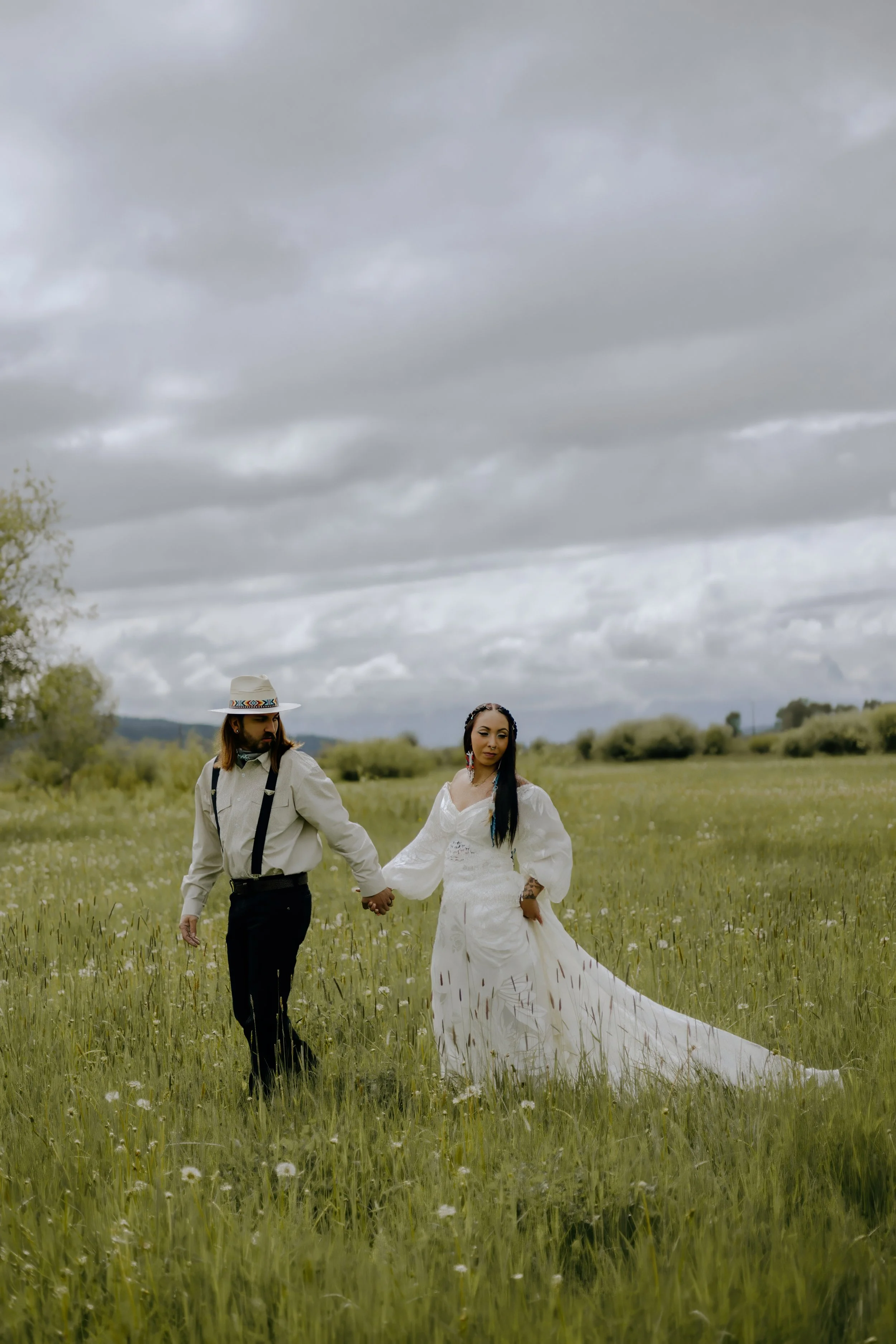 Houston & Texas Wedding & Elopement Photography – Couple walking hand-in-hand across meadow at Diamond Cross Ranch, Jackson WY.